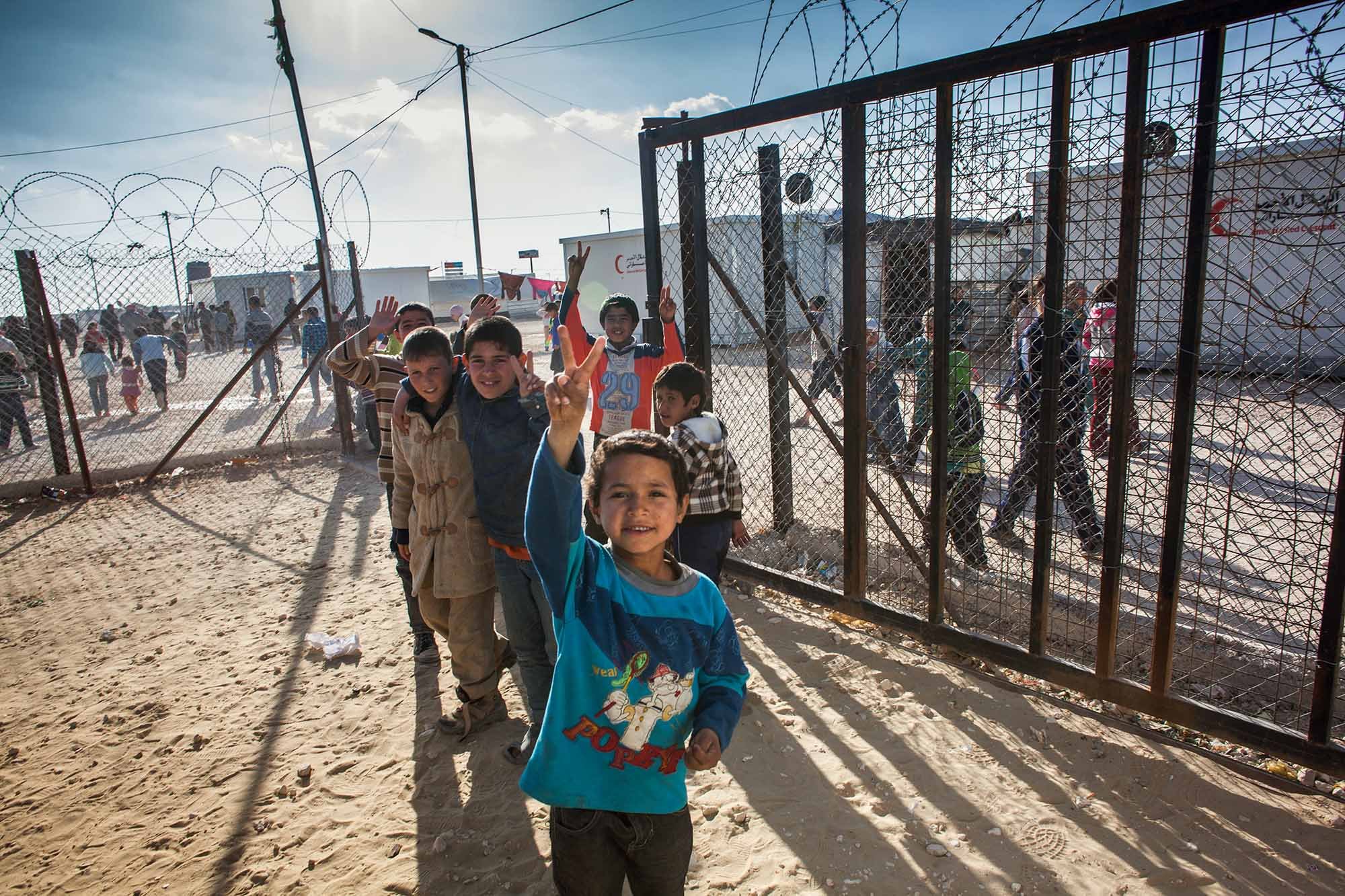  Syrian boys at Zaatari camp make a peace sign as they leave a Clowns Without Borders Ireland performance.&nbsp; 