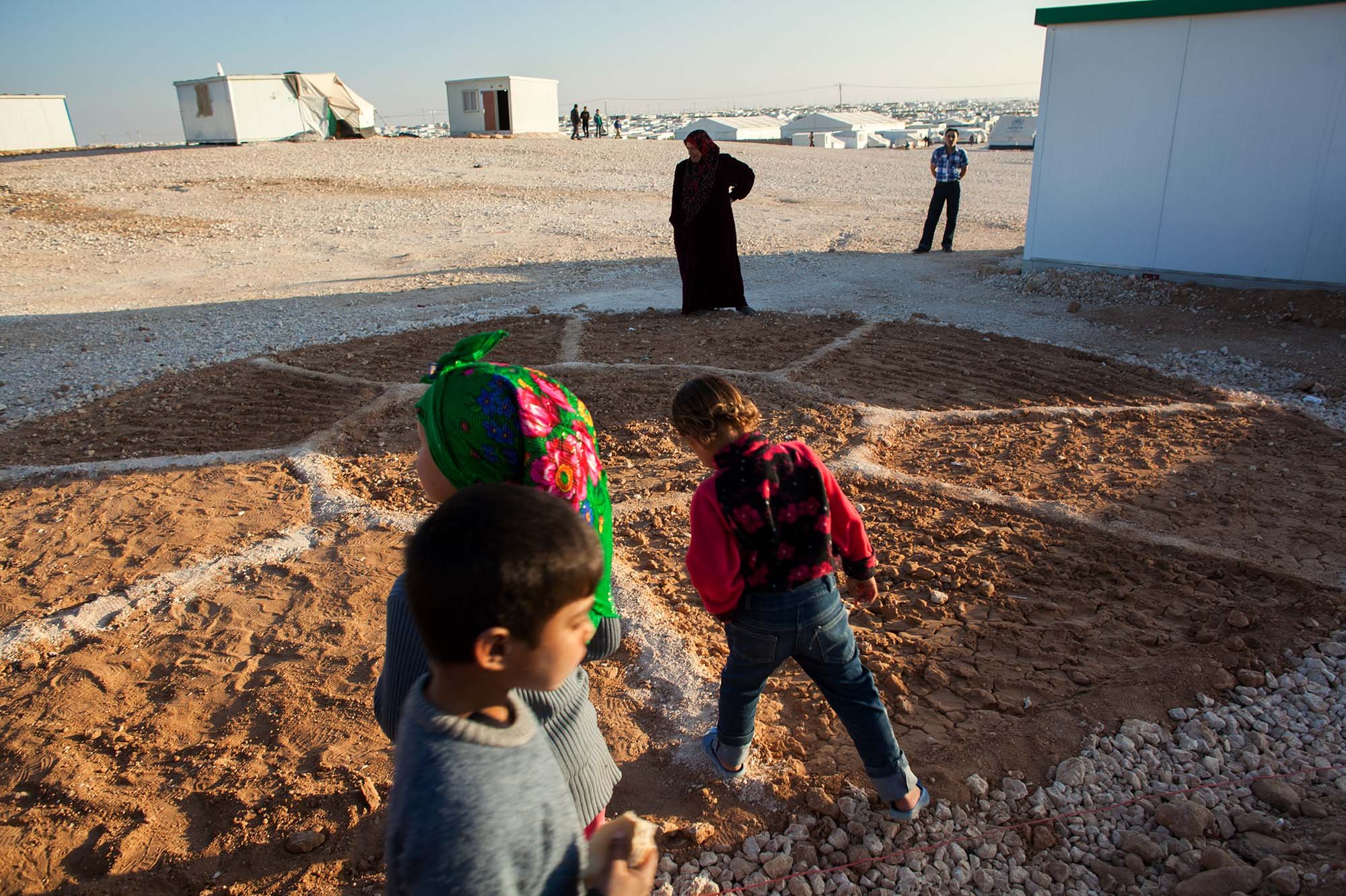  Kids play near a newly planted community garden in a corner of district 4 in Zaatari refugee camp.&nbsp; 