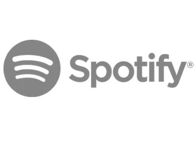Spotify logo in gray, featuring a circle with three curved lines and the word 'Spotify' next to it.