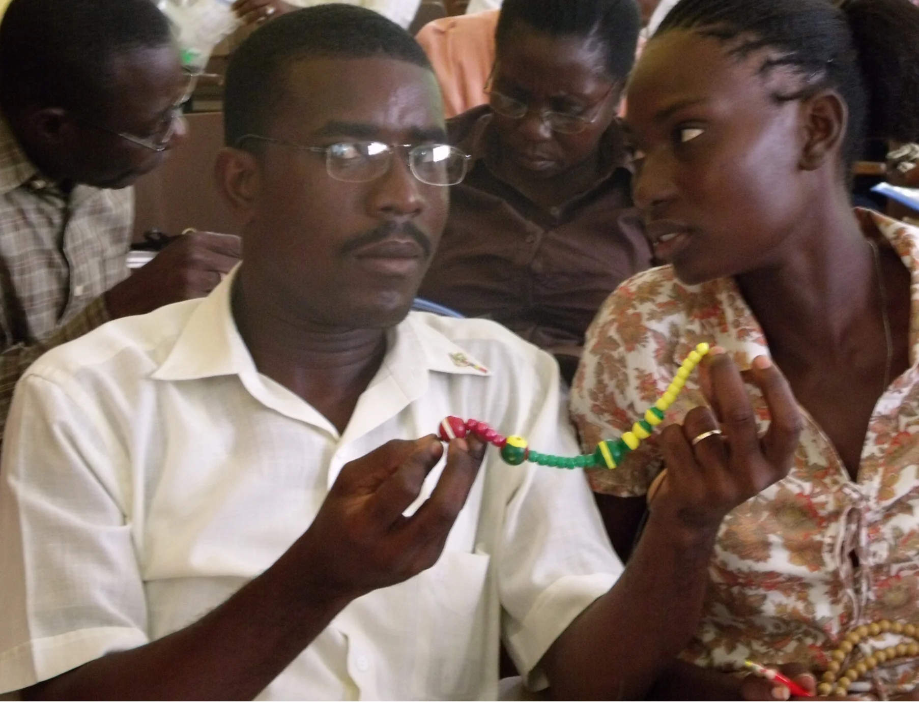 A couple learning about natural family planning with the bead method.