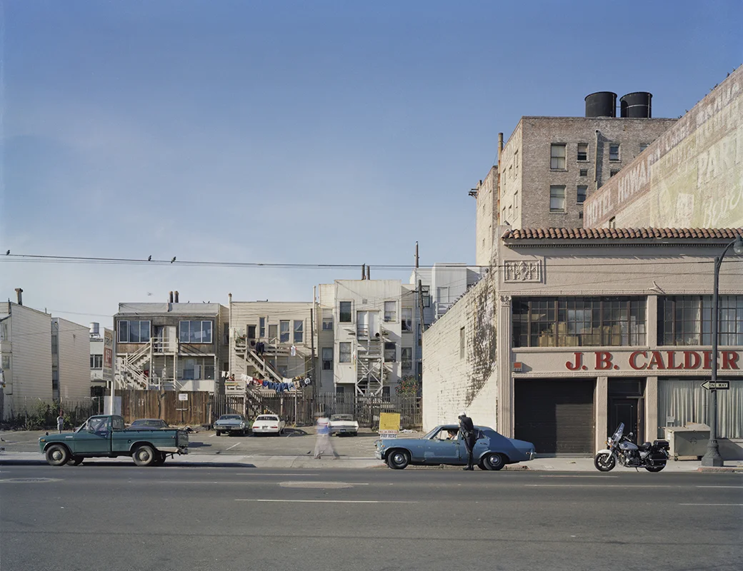 Policeman writing a ticket, Howard near 6th Street, 1980