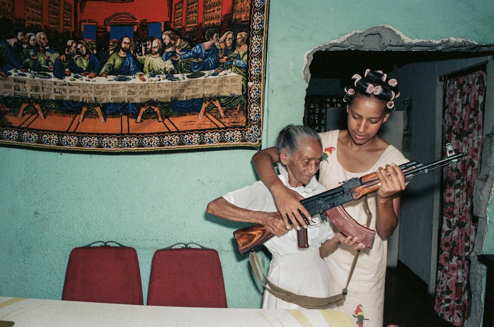Milena Montano helps her great aunt, La Conchita, pose with the AK47.