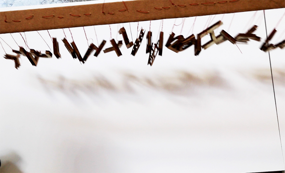 Another attempt at shadow as artifact: I created a mobile of the individual letters from the phrase and attempted to capture the shadow in order to find results that could stand as letterforms.