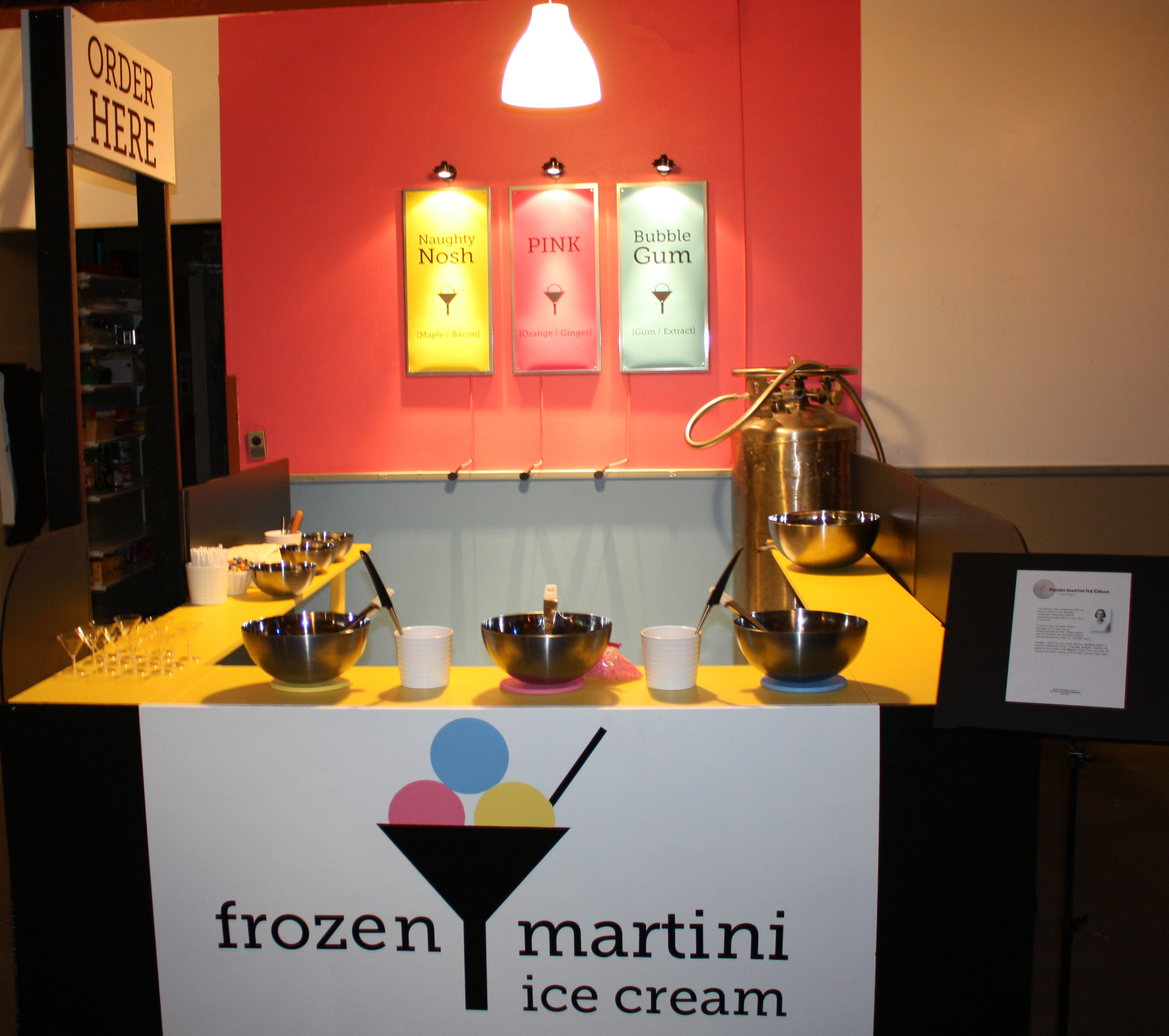 This is the stand on the night of Personal Statements, ready to go. Check out the Liquid Nitrogen Dewar in the back corner and the color-coded ice cream bowls. Up front is where the ice cream making happened. The batches were then transferred to the smaller bowls on the side for serving.