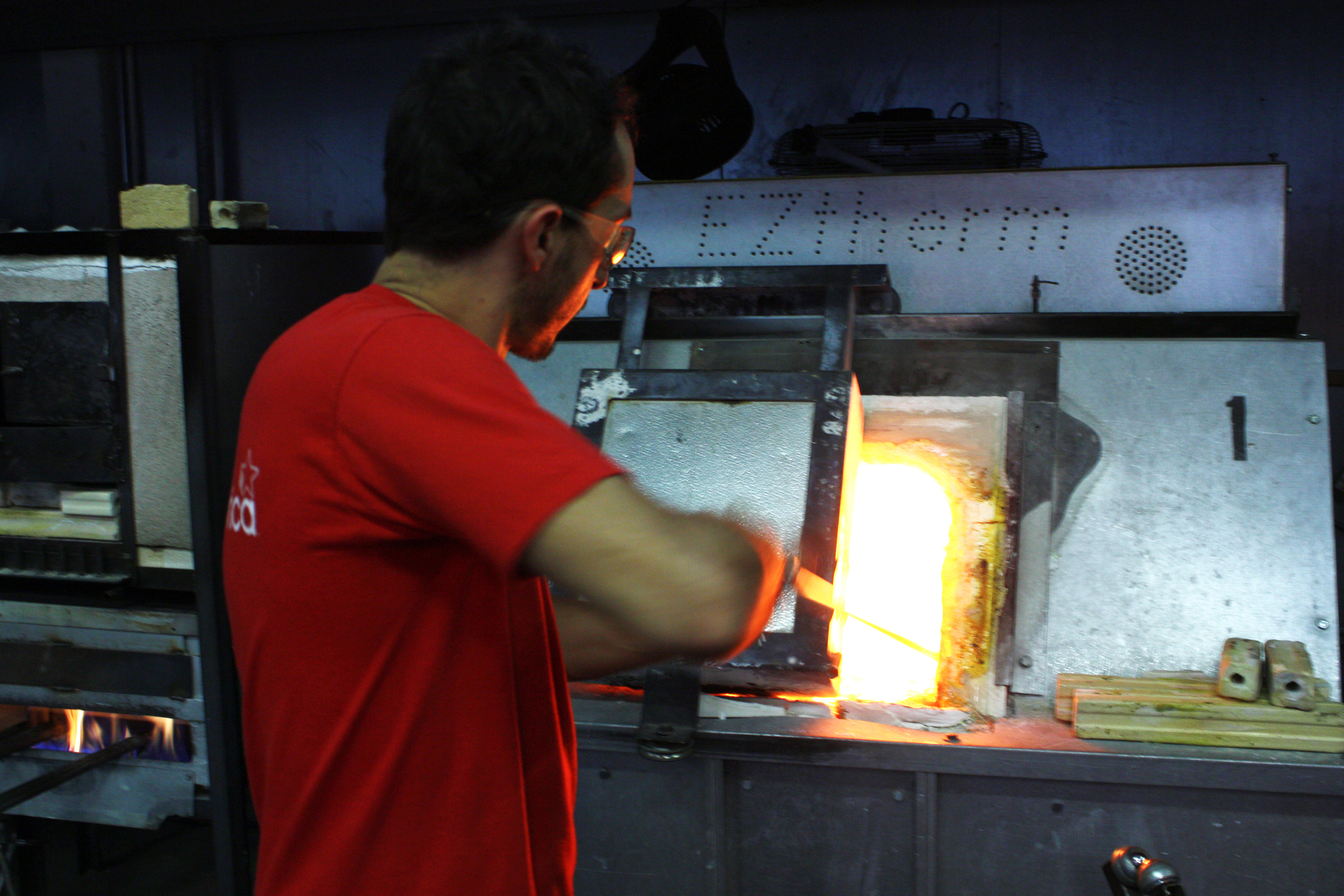   The process starts when Esteban takes some glass from the main furnace, which holds a big bowl of melted glass.  