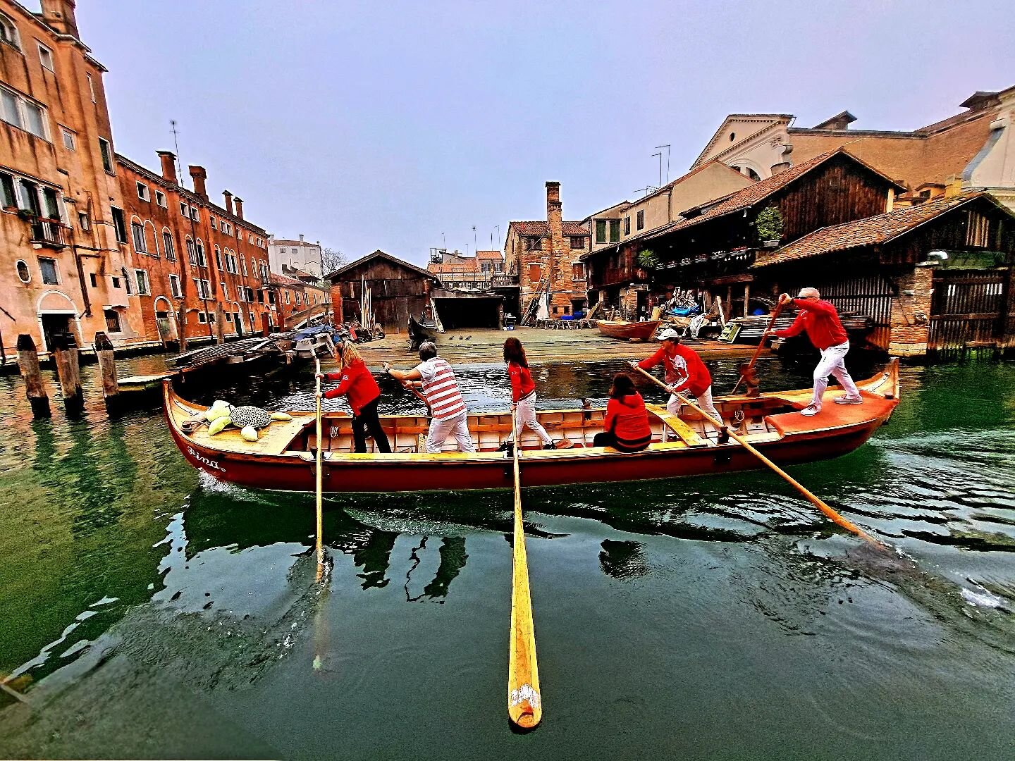 Under the vibrant Venetian sky, the Squero di San Trovaso comes alive, its colors as vivid as the city&rsquo;s rich history. A caorlina glides gracefully by, adding a stroke of life to this picturesque scene of tradition and craftsmanship. This momen
