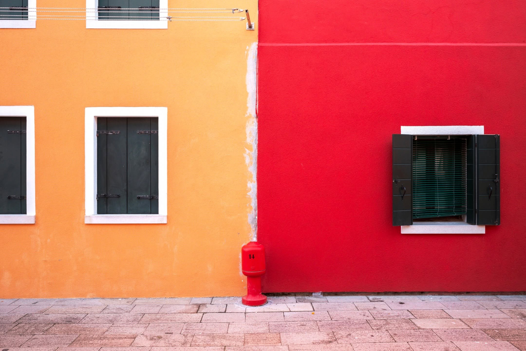 This is Burano Too

Burano doing what Burano does best, arguing with itself in colour and somehow winning.

Two walls, one street, zero compromise. Geometry, shutters, and that little red hydrant pretending it planned this all along.

Leica, because 