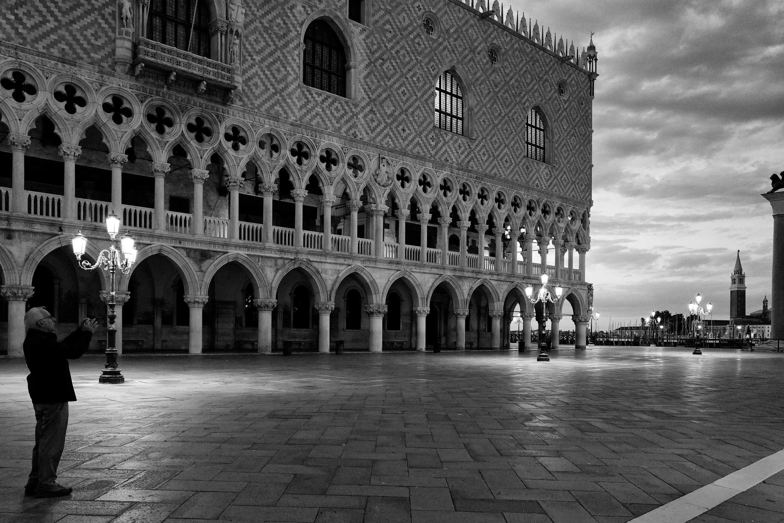 Some places become louder when they are empty.

Venice at dawn has a strange honesty to it.
No crowds. No noise. Just light, stone, silence&hellip; and one man standing still beneath the lamps, as if listening to the city breathe before the day begin