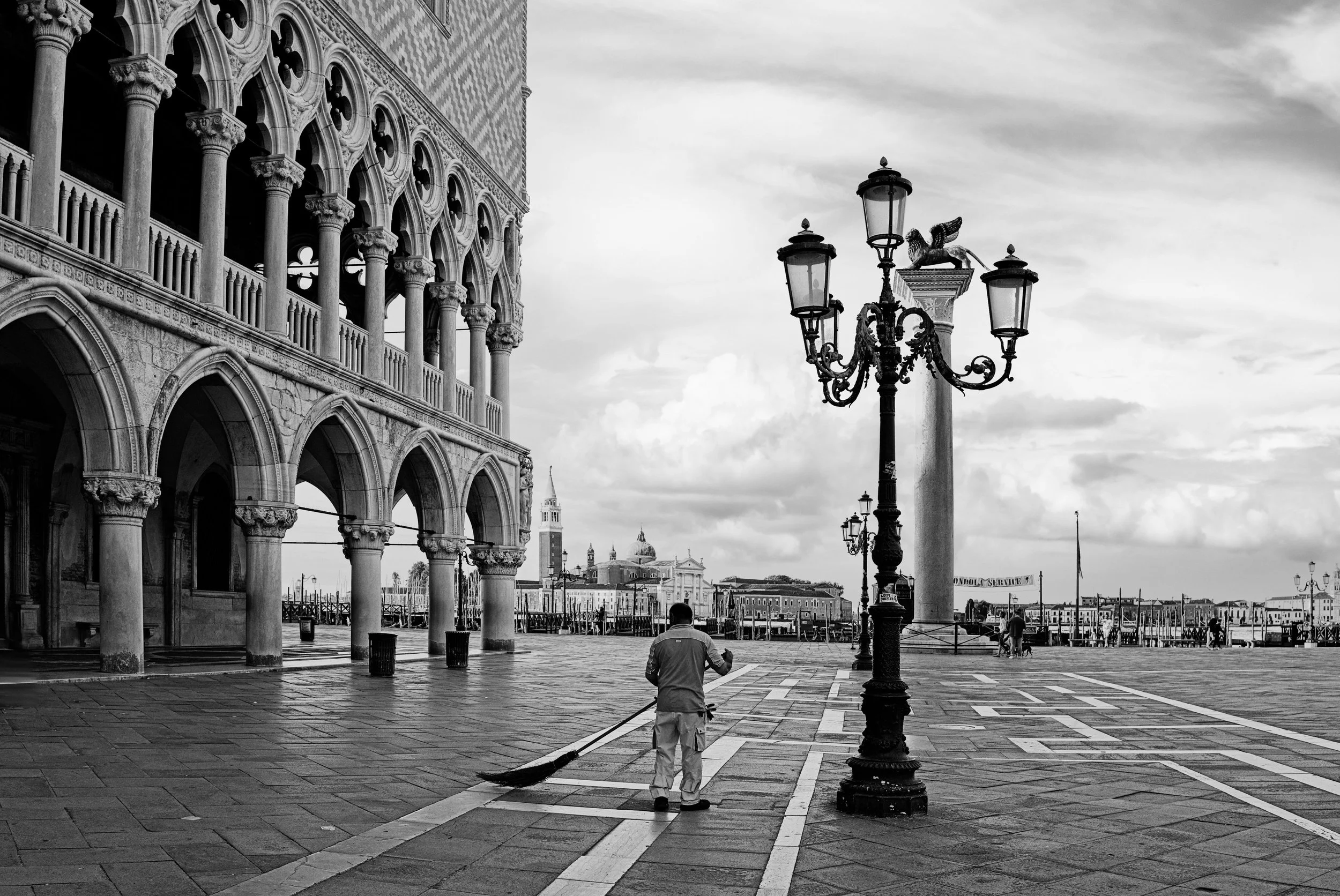 Some cities wake up slowly.
Venice wakes up in silence.

Before the crowds, before the noise, before the performance of tourism begins again, there is this moment. A man, a broom, wet stones, and a square that briefly belongs to itself again.

This i