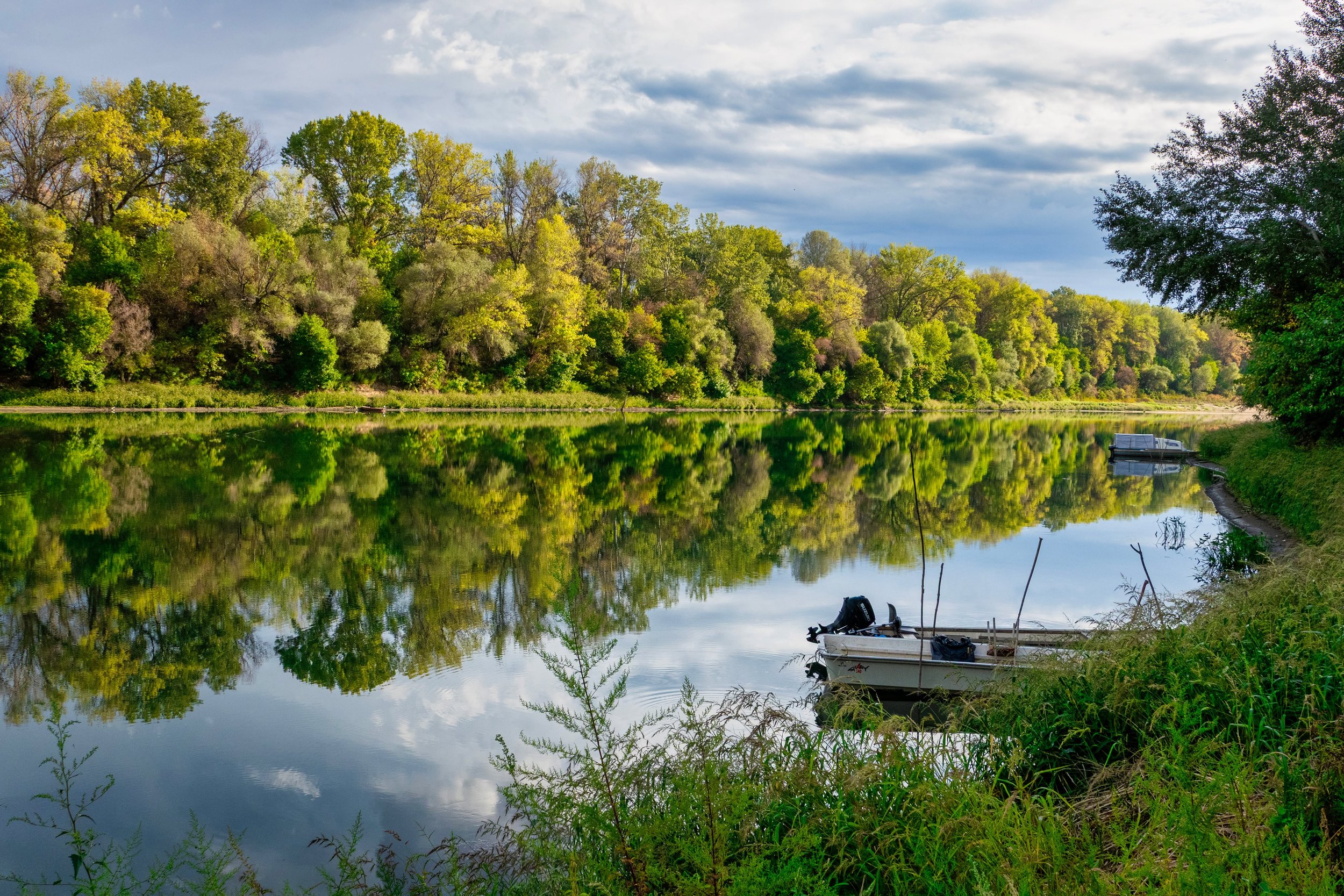 The first thing Nagyr&eacute;v gives you is silence.

The Tisza barely seems to move, the trees repeat themselves in the water, and the small boats wait along the bank. 
Even the ferry is still.

It began as a simple notice, but for me it came to des