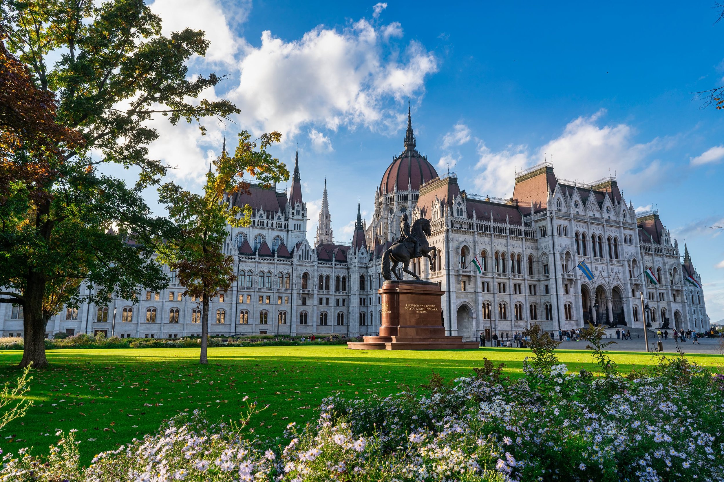 Budapest gives you plenty to point a camera at. The interesting part is deciding where to stand, what to include, and how to make a familiar view your own. Here, the flowers and trees give the Parliament building a setting, while the light carries th