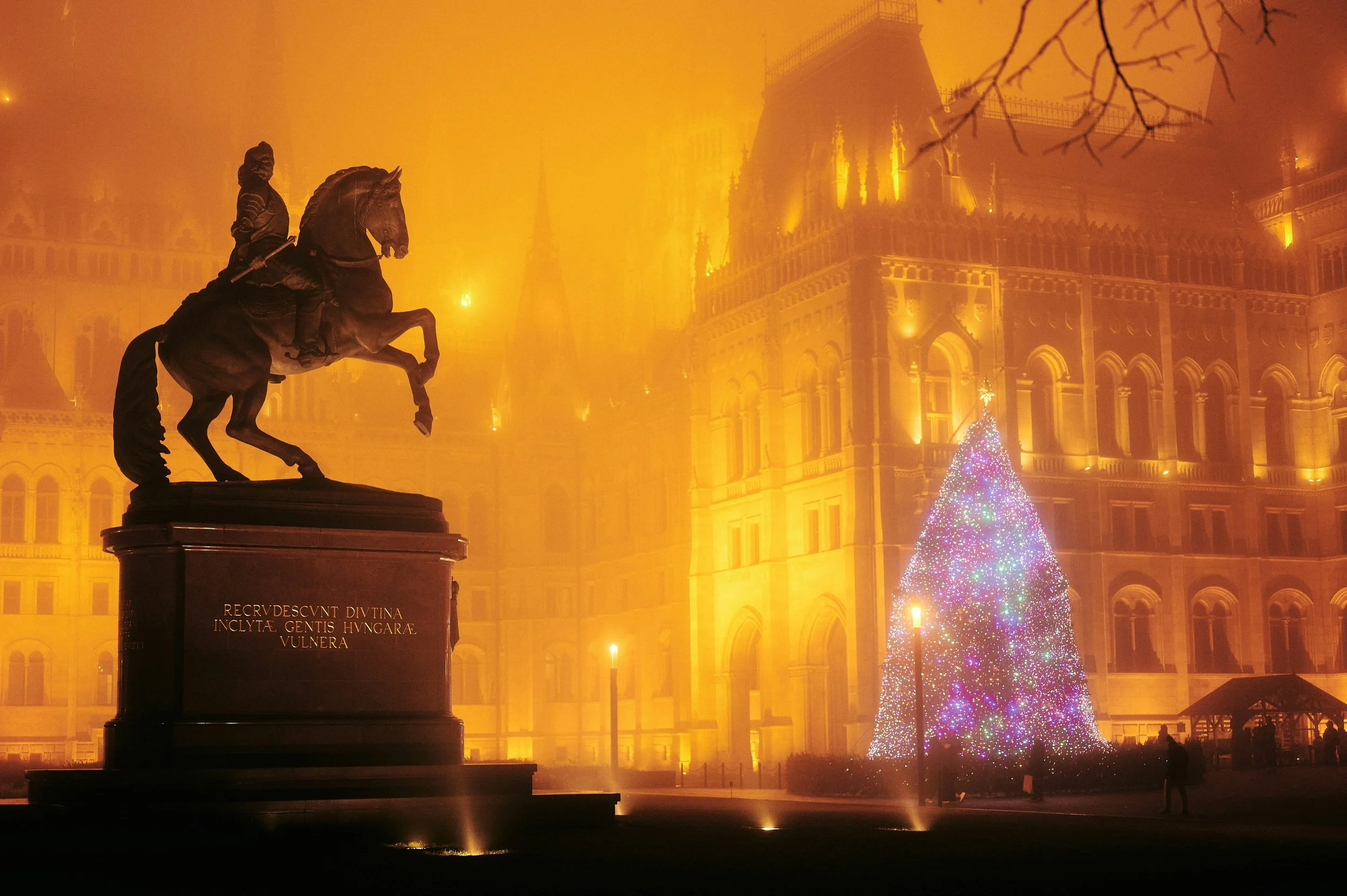 The Christmas lights are only part of the picture. In Budapest, a passing tram, reflections on wet streets, and mist-softened buildings can give an evening photograph its character. 

The interesting decisions are where to stand, what to leave out an