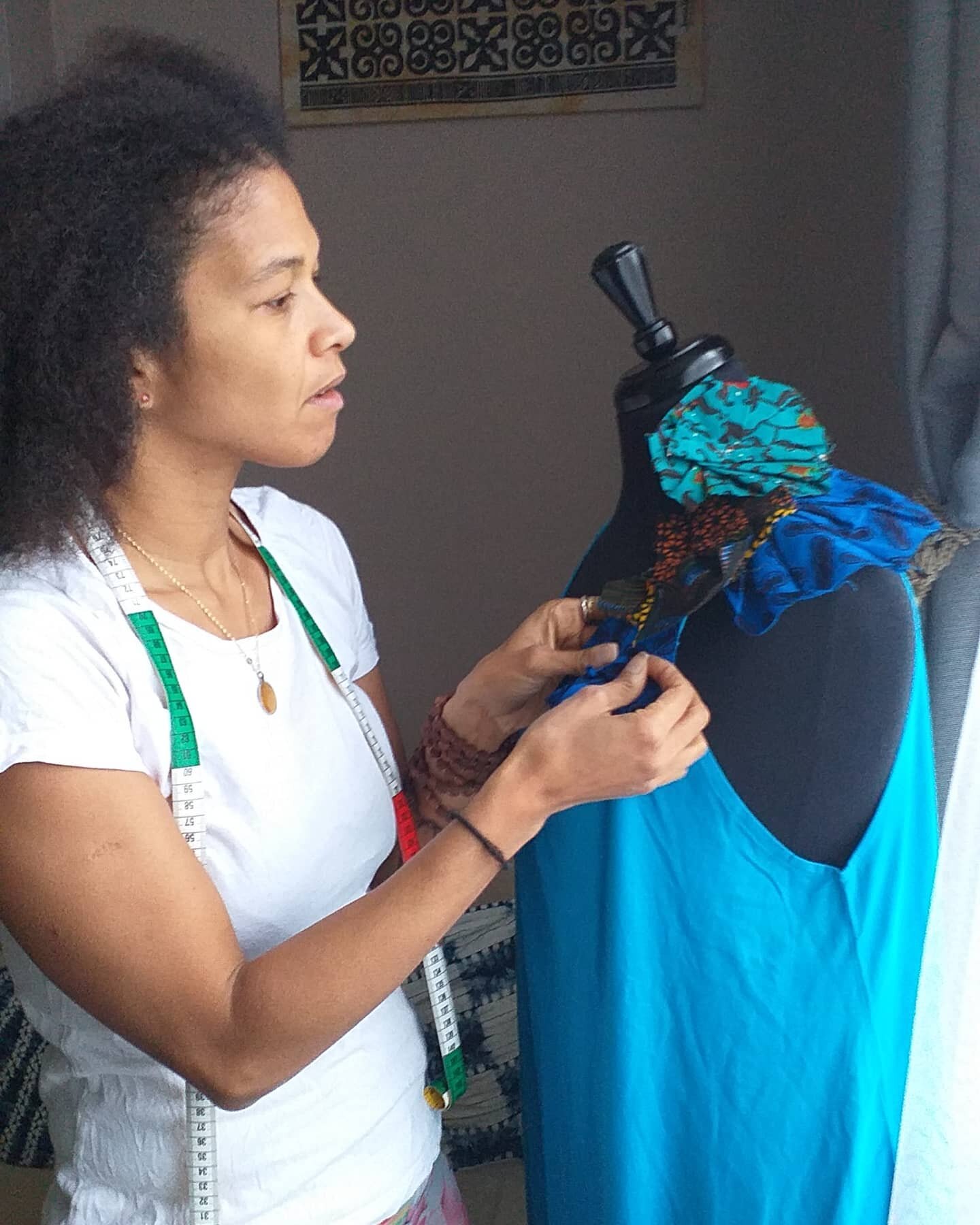 Handsewn final touches. The contract of using stretch cotton Jersey in a jumpsuit with non stretch African print flowers and  is a trial I played with on some T-shirts which have turned out well, loved the frayed edges. Colour play with blues, torqui