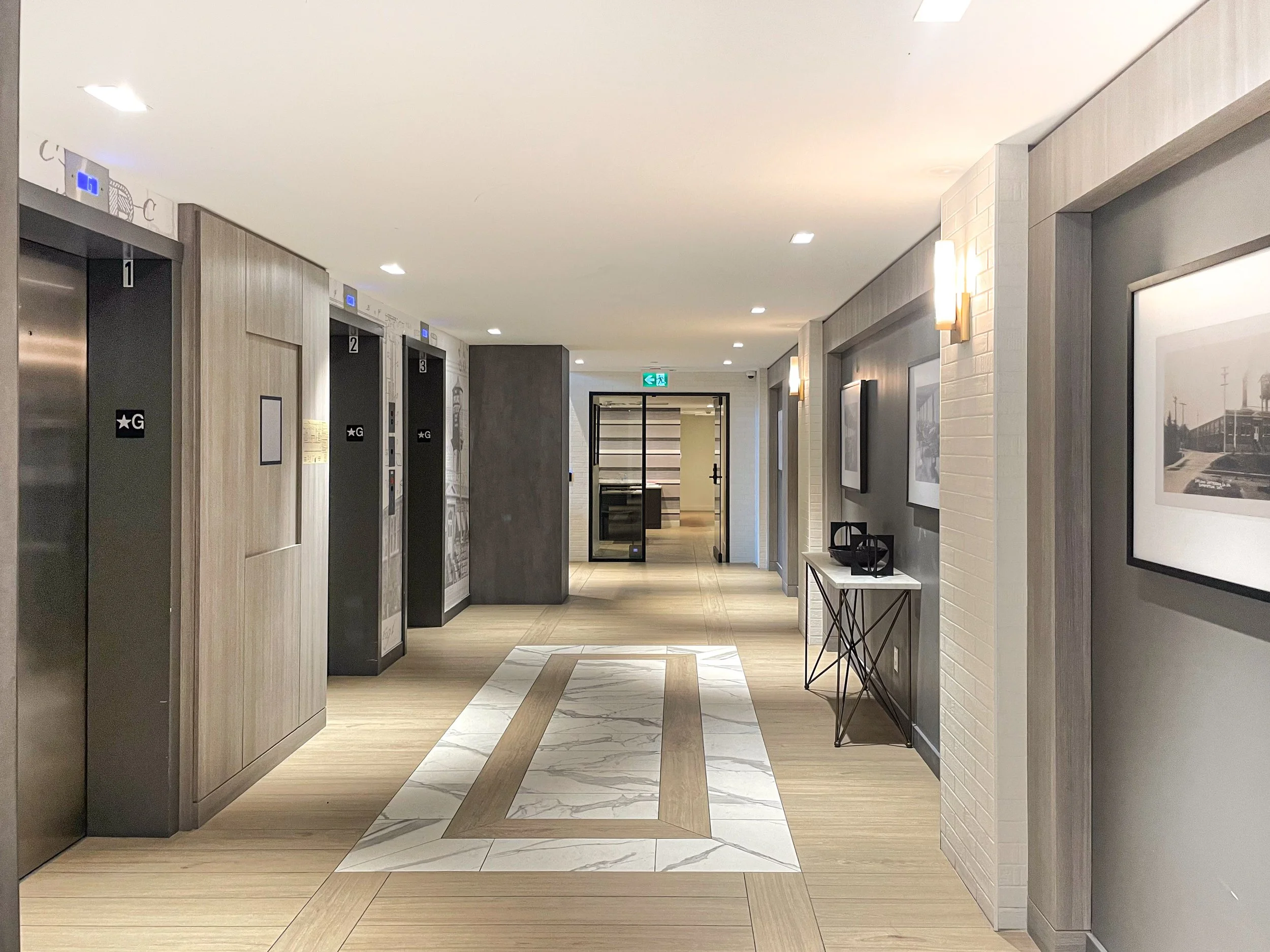 Condo Elevator Lobby with Wall Sconces by Studio 8 Design