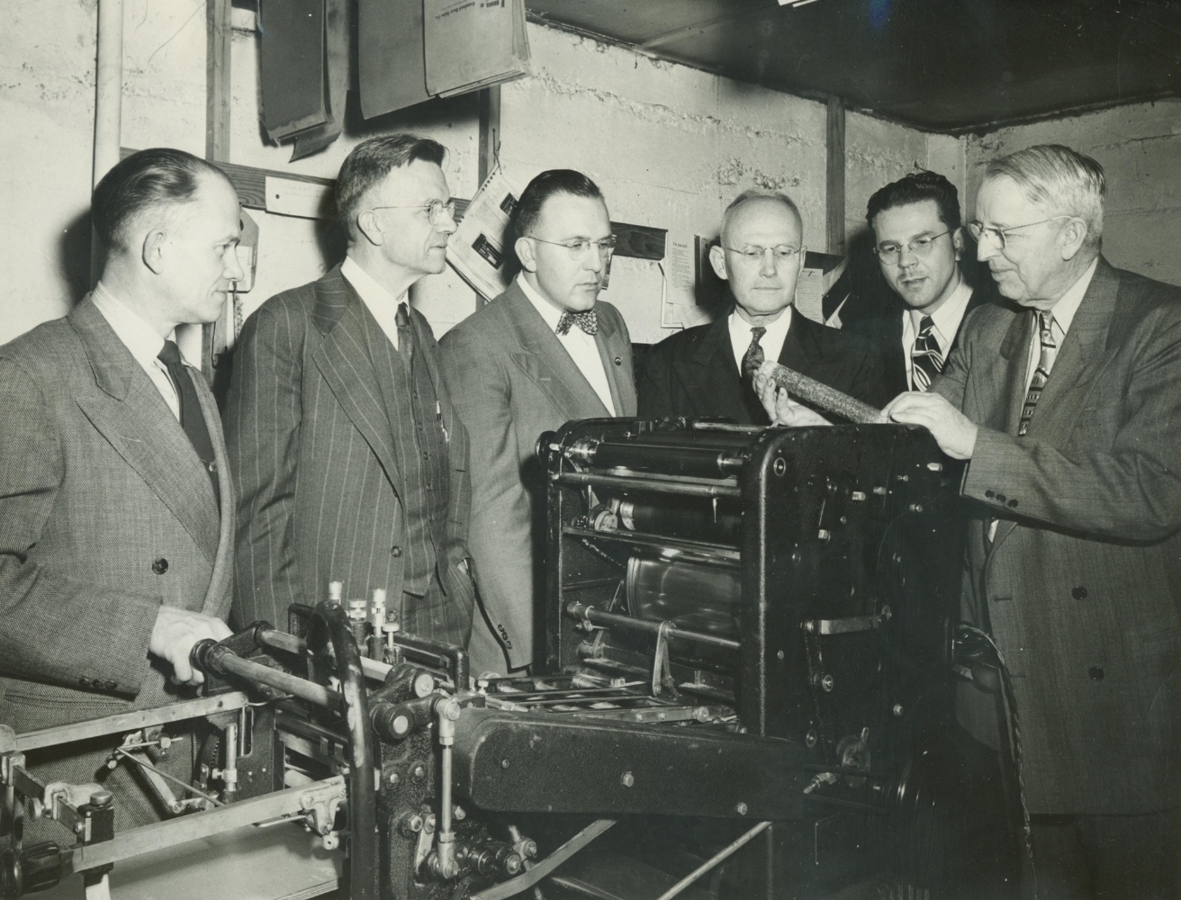   Ray Carter (right) shows a newly acquired press to the Oregon Yearly Meeting publications board.  