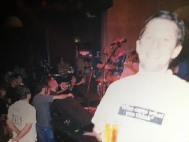 Ben with Mike Watt on stage in the background.