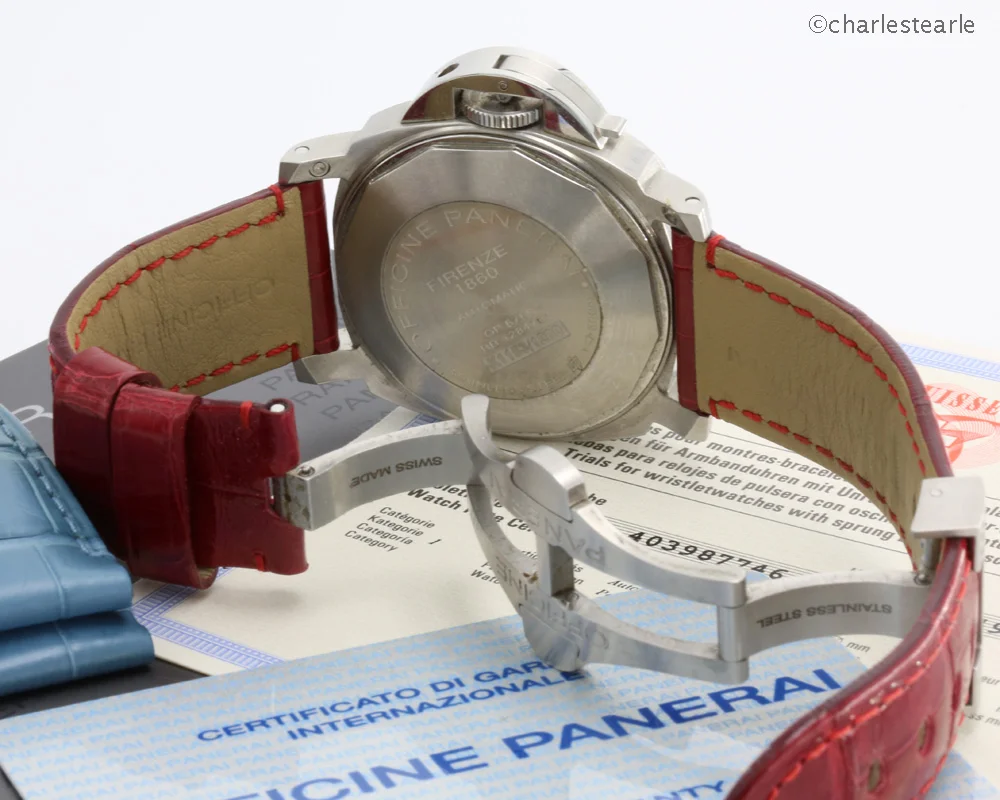 The watch is being offered with the original Panerai steel double folding/locking buckle, instruction booklet, COSC, stamped and dated (now void) warranty card, (lightly worn) matt blue, shiny red and black OP straps. Original light wood Panerai presentation box with strap removing tool and screwdriver.