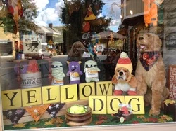 Yellow Dog's cute window. Always ready to celebrate the holidays. Be on the lookout for a new fuzzy friend hanging out in the window very soon!