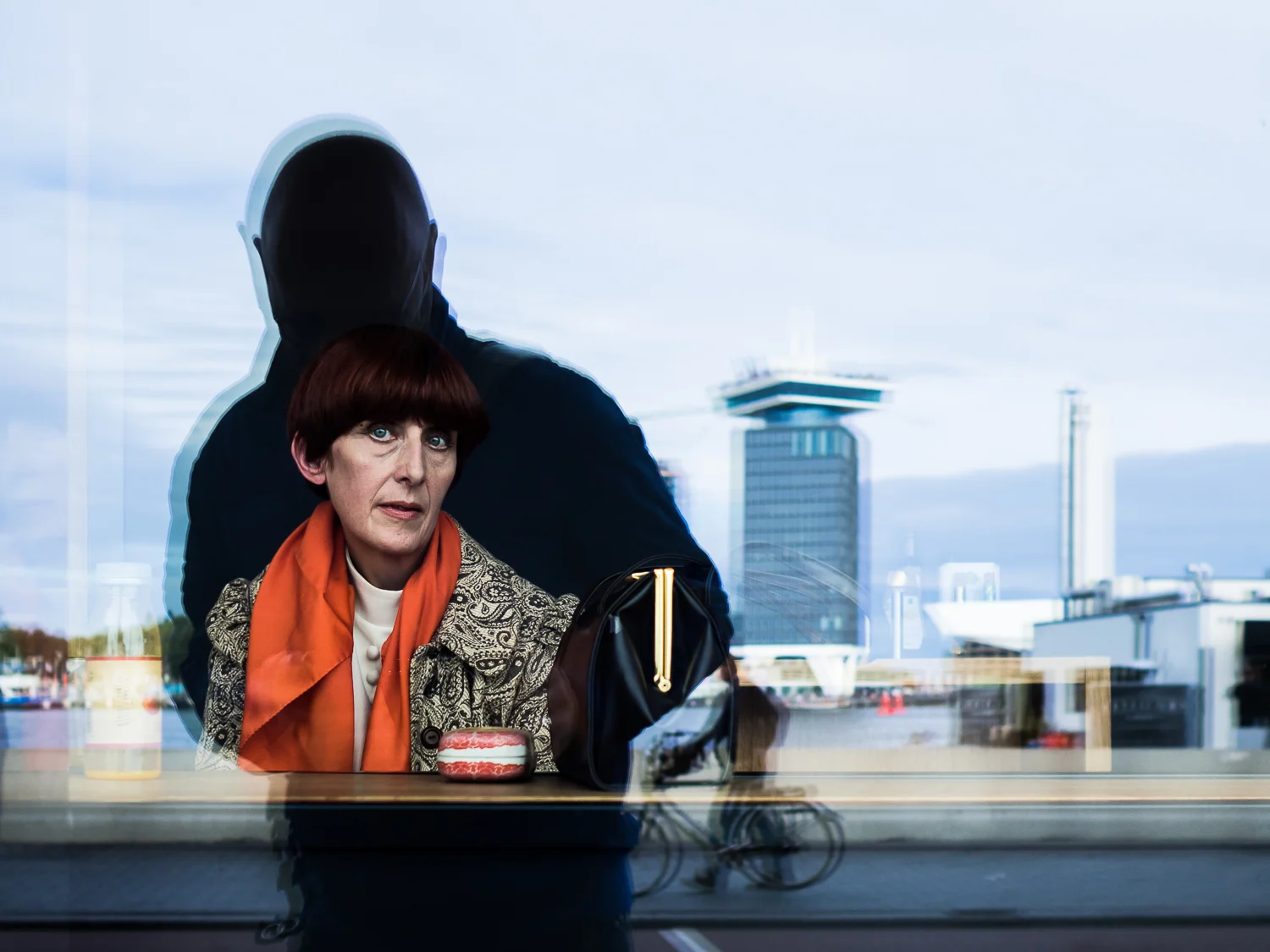 AmsTERDAM october 2016 Shot taken at the back side of the Central Station. I showed some participants of my workshop street photography how to deal with the reflections. The camera can't see through these windows so you can use your body to frame the shot. Part of my Glassy series. One of favorites of 2016. Shot with Olympus OMD5 Mark 2 and Olympus 17mm f/1.8
