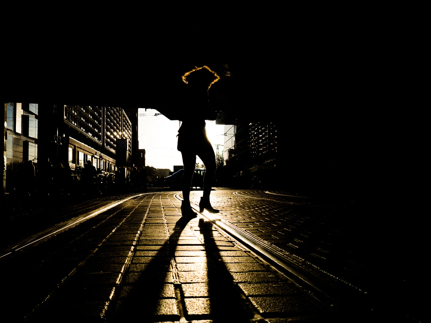 Shot taken in Berlin. The sun was setting very fast and I didn't have much time. It was crowdy and difficult to shoot an isolated person. Then she arrived and I was in time. I like the sun in her hair. Shot with Olympus OMD5 Mark 2 and Olympus 17mm f/1.8