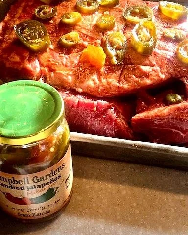 Smoky pork butt burnt ends with candied jalapeños, caramelized BBQ glaze, and crispy edges on a serving dish