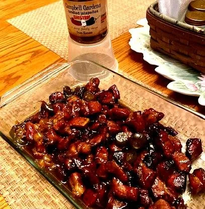 Smoky pork butt burnt ends with candied jalapeños, caramelized BBQ glaze, and crispy edges on a serving dish