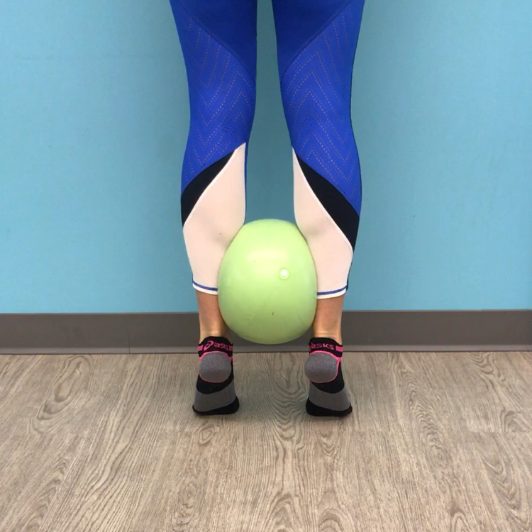 Double leg calf raise with ball squeeze