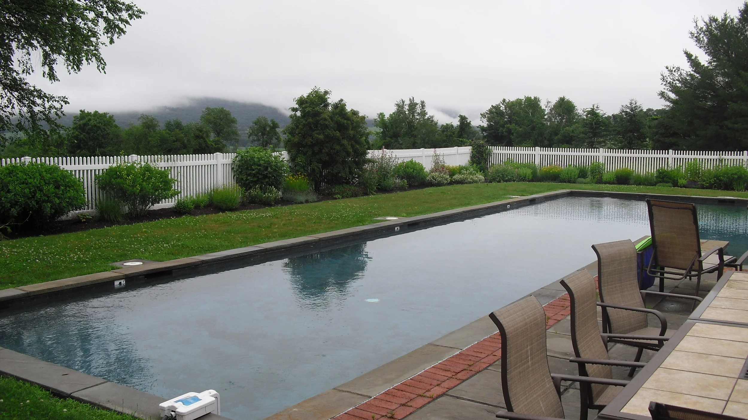 Before photo showing old picket fence 