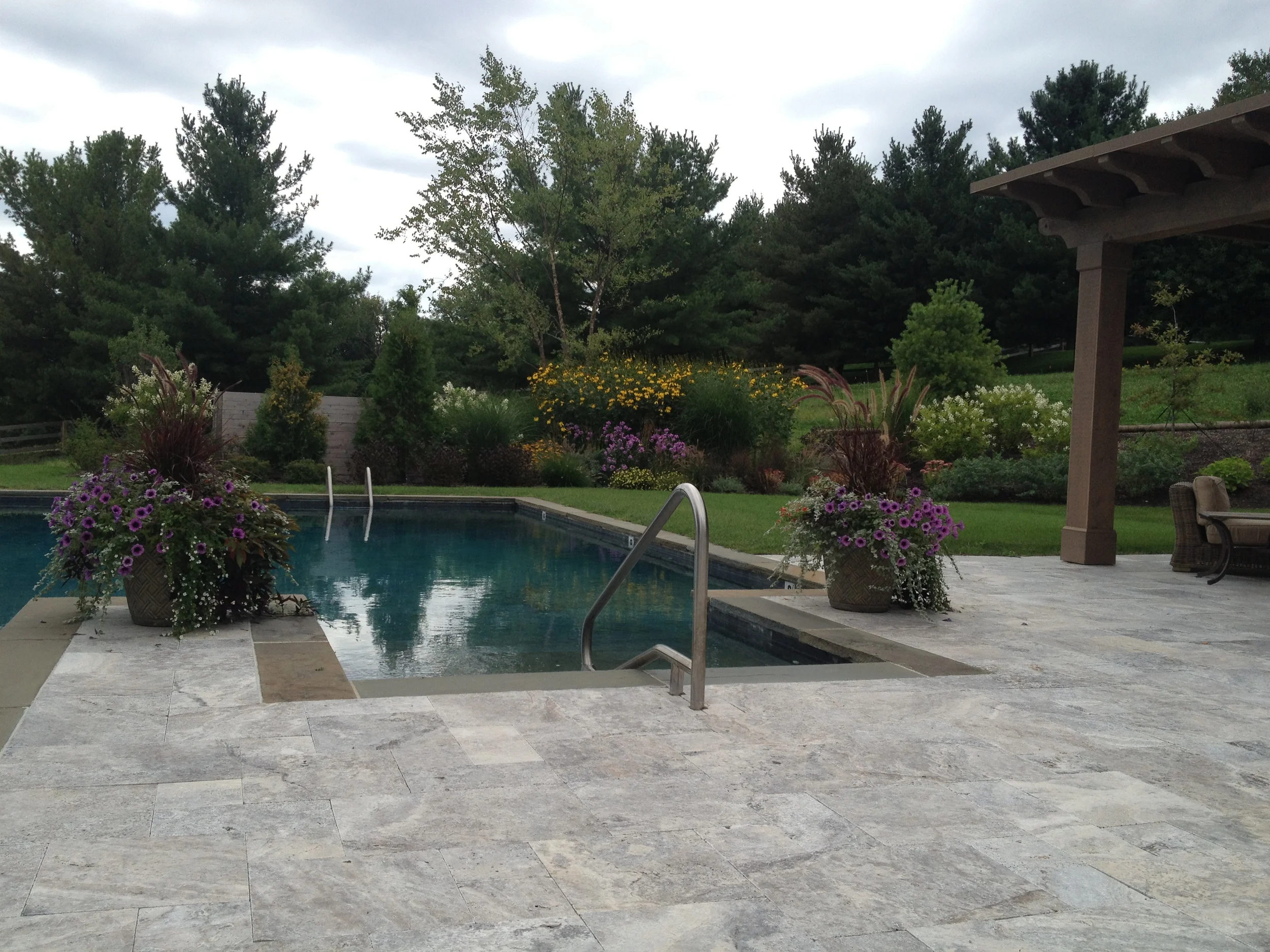 Travertine patio with bluestone pool coping