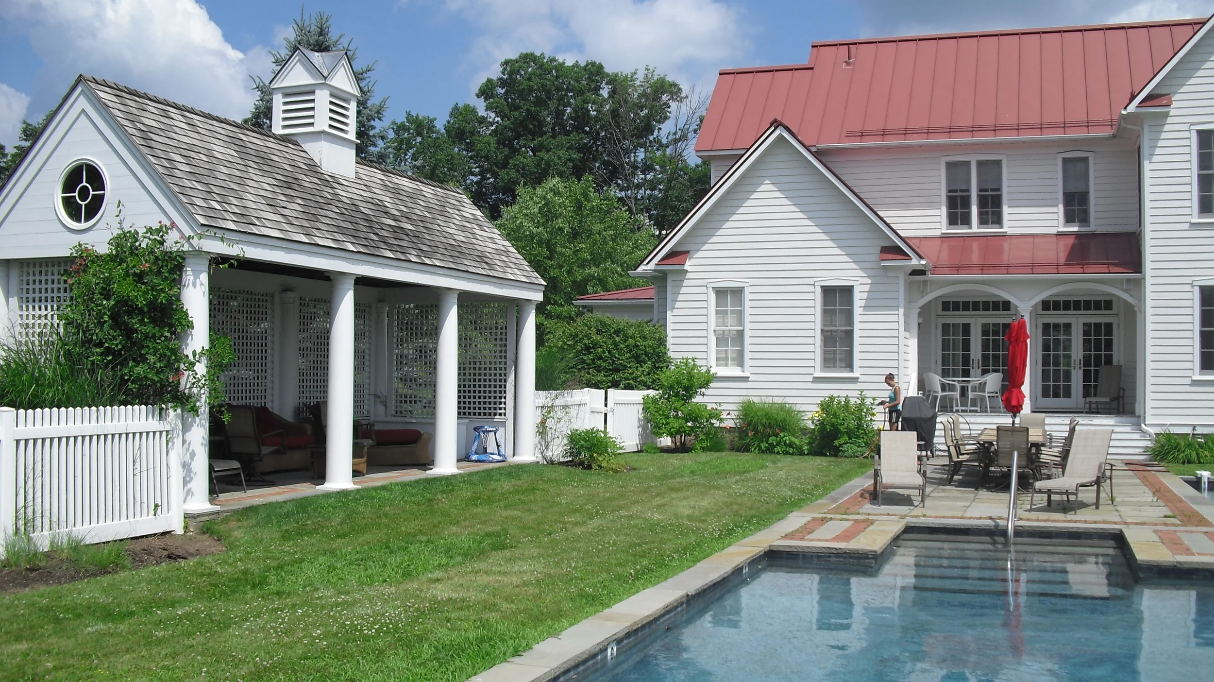Before photo showing old pool house and old patio