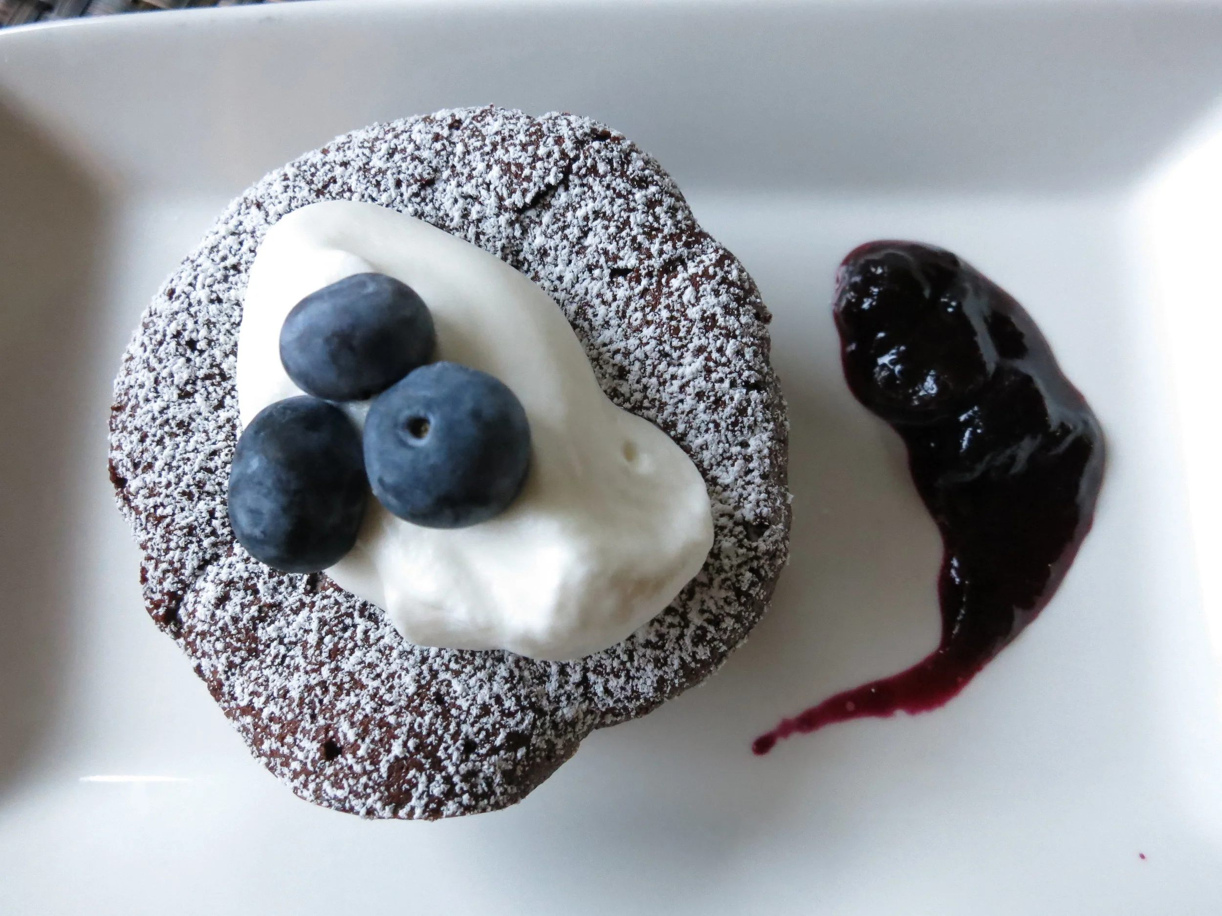 Flourless Dark Chocolate Cake with mixed Berry Compote and Rum whipped Cream