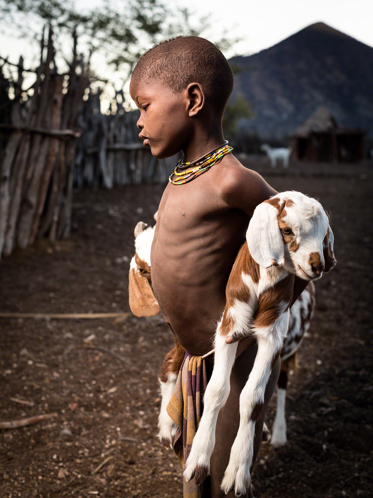Himba child with favourite goat, Epupa Falls, Namibia