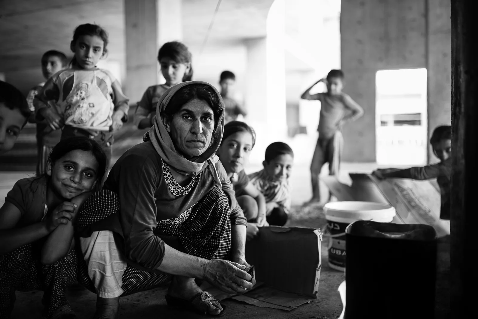 Yazidi mother and children in Zakho under construction building