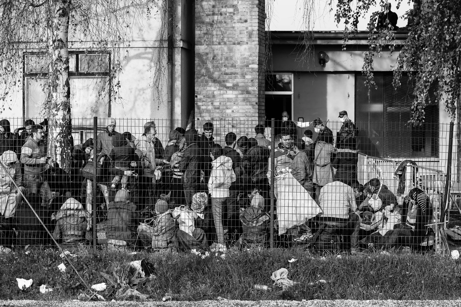 Migrants behind the fence of a camp