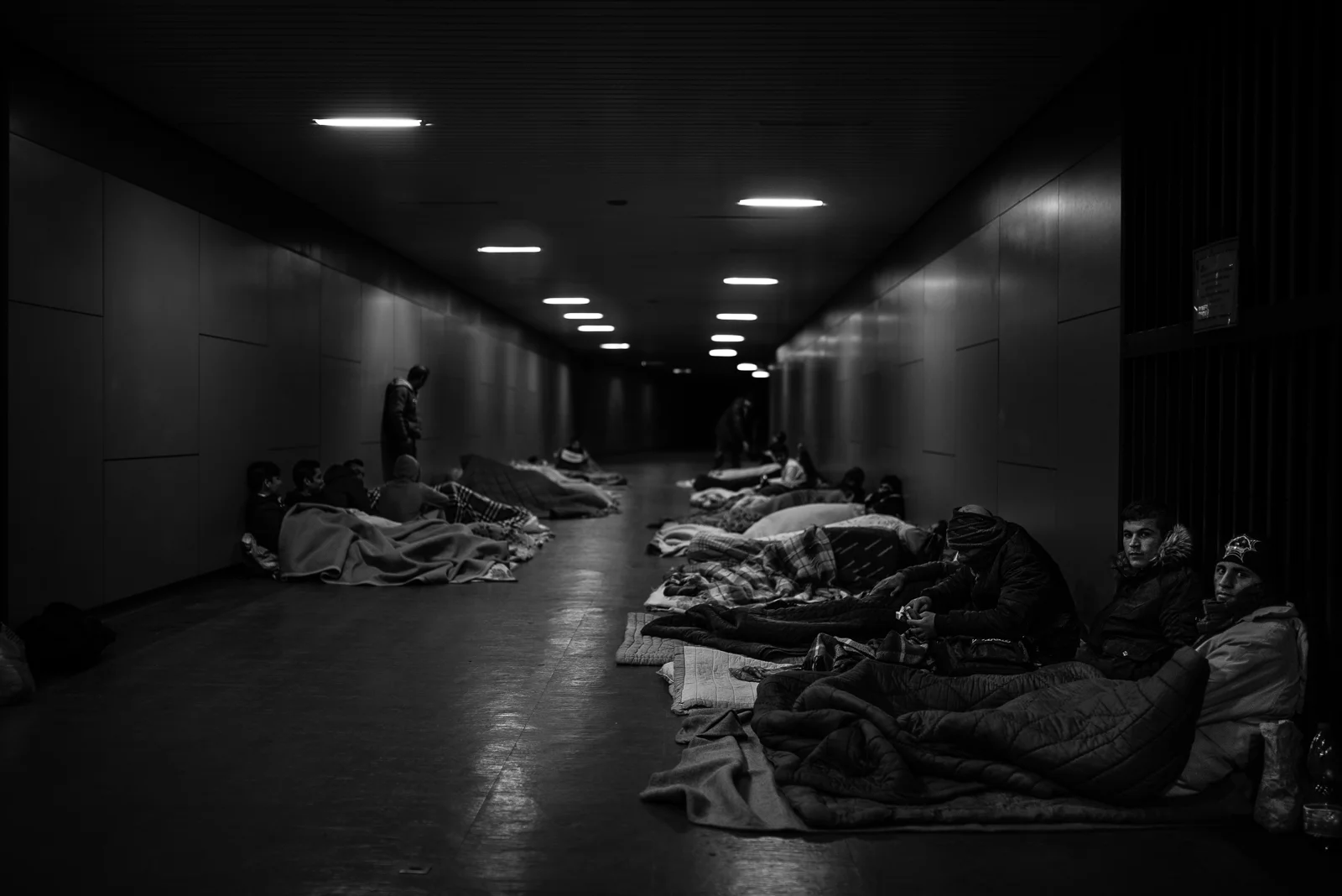 Migrants are sleeping in a tunnel of the railway station
