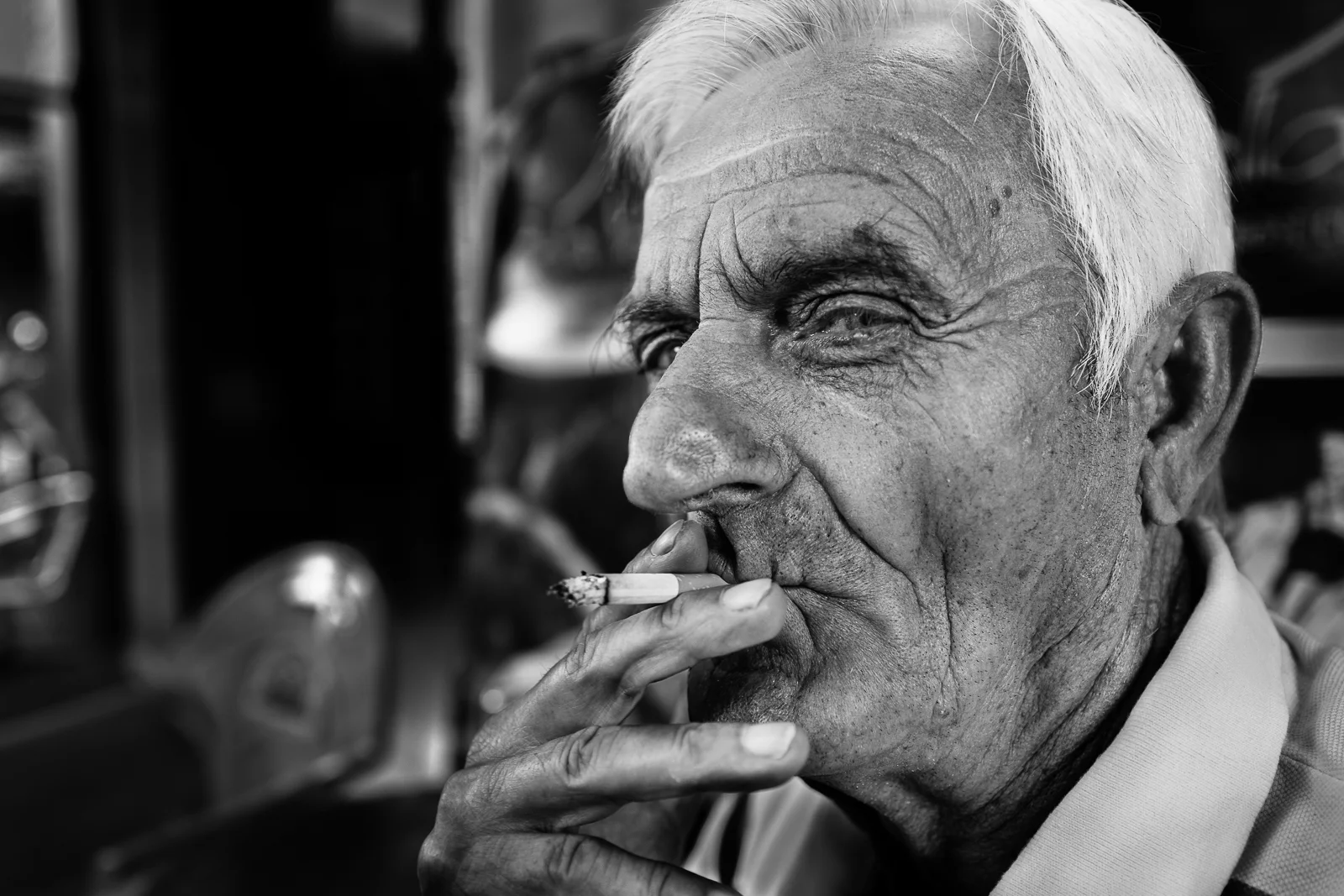 A man is smoking his first cigarette in the early morning