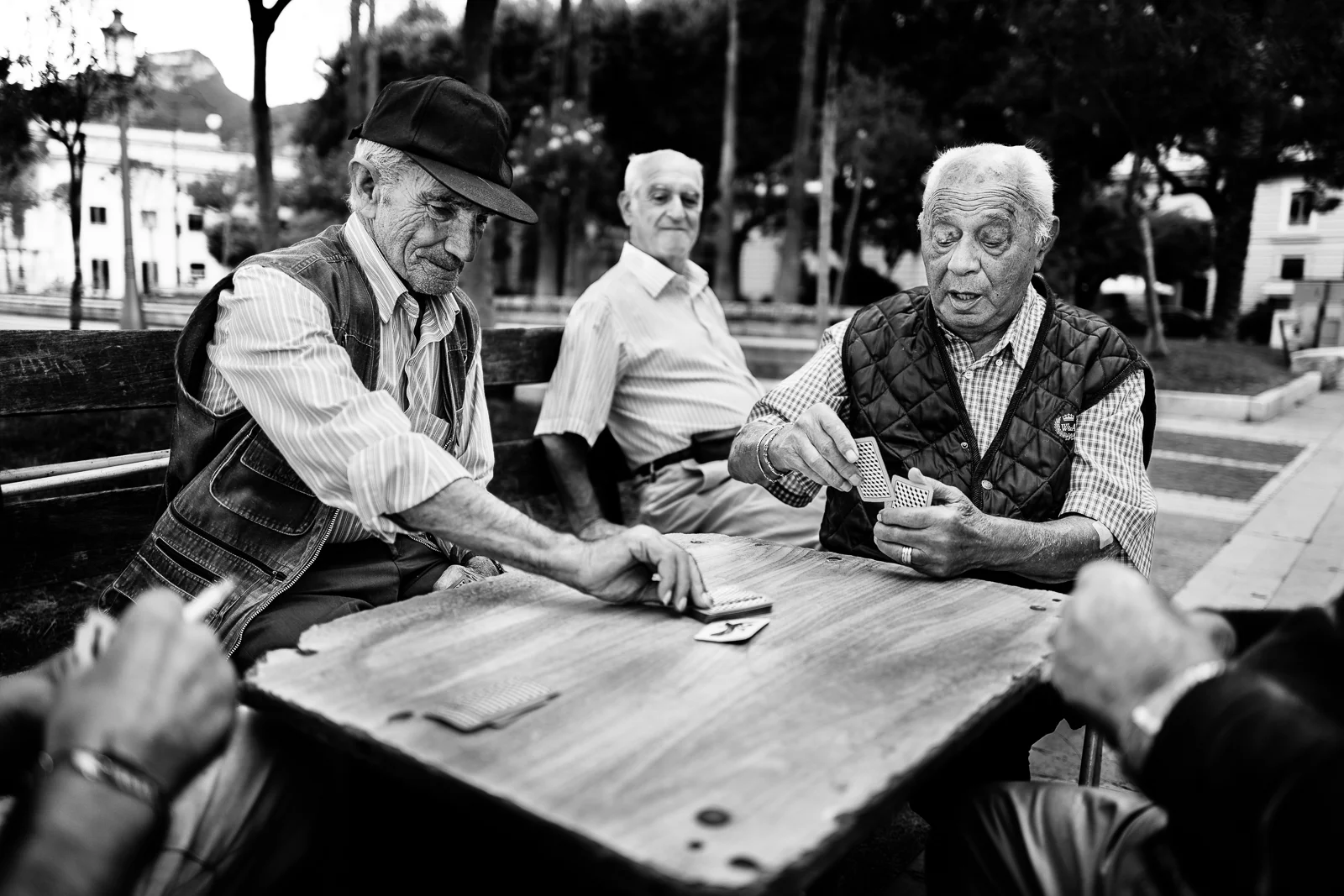 Friends are playing card on the promenade
