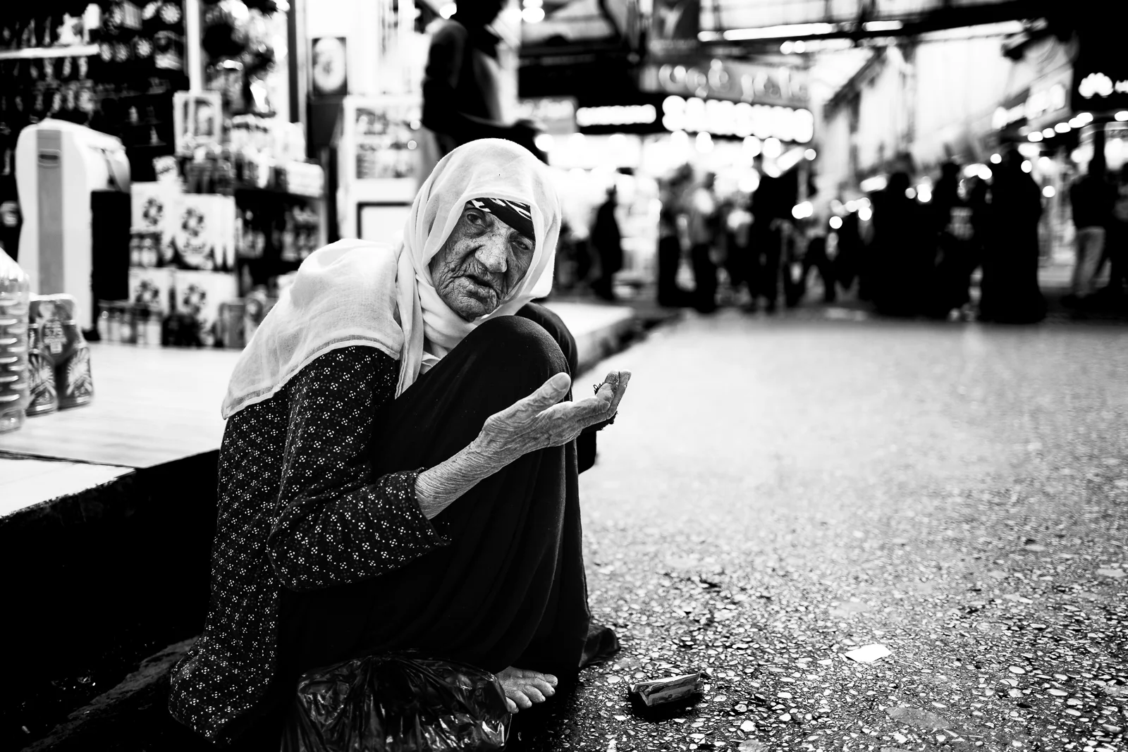 A beggar woman in the Douhk bazaar