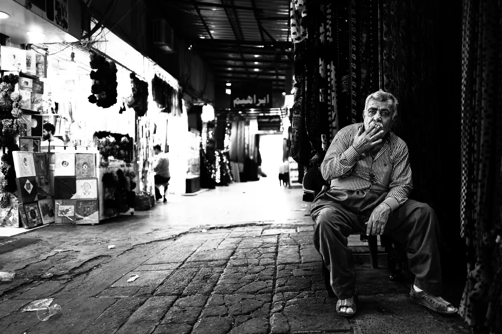 A carpet seller is taking a rest. Erbil bazaar