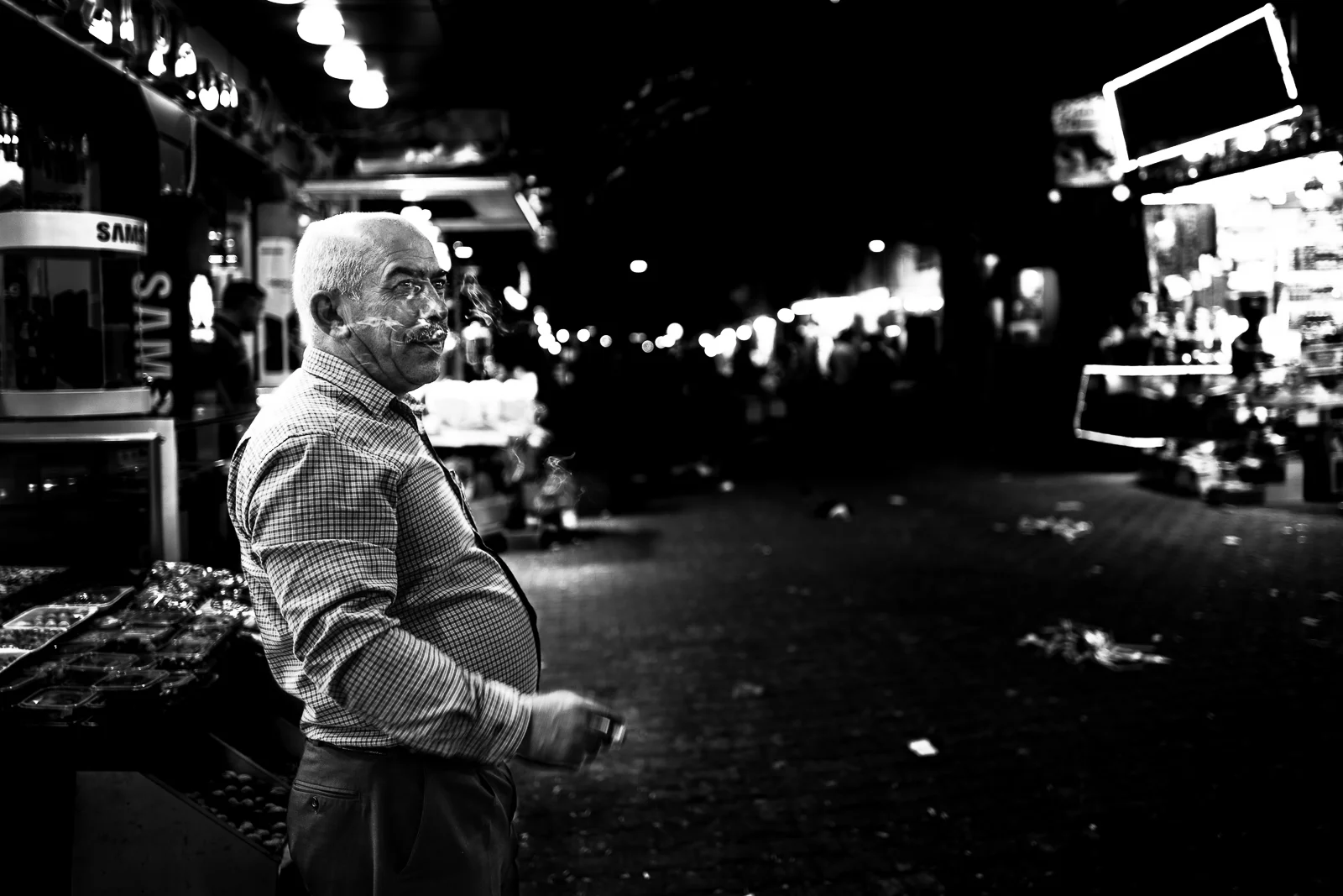 A man is taking a cigarette pause in the Zakho bazaar
