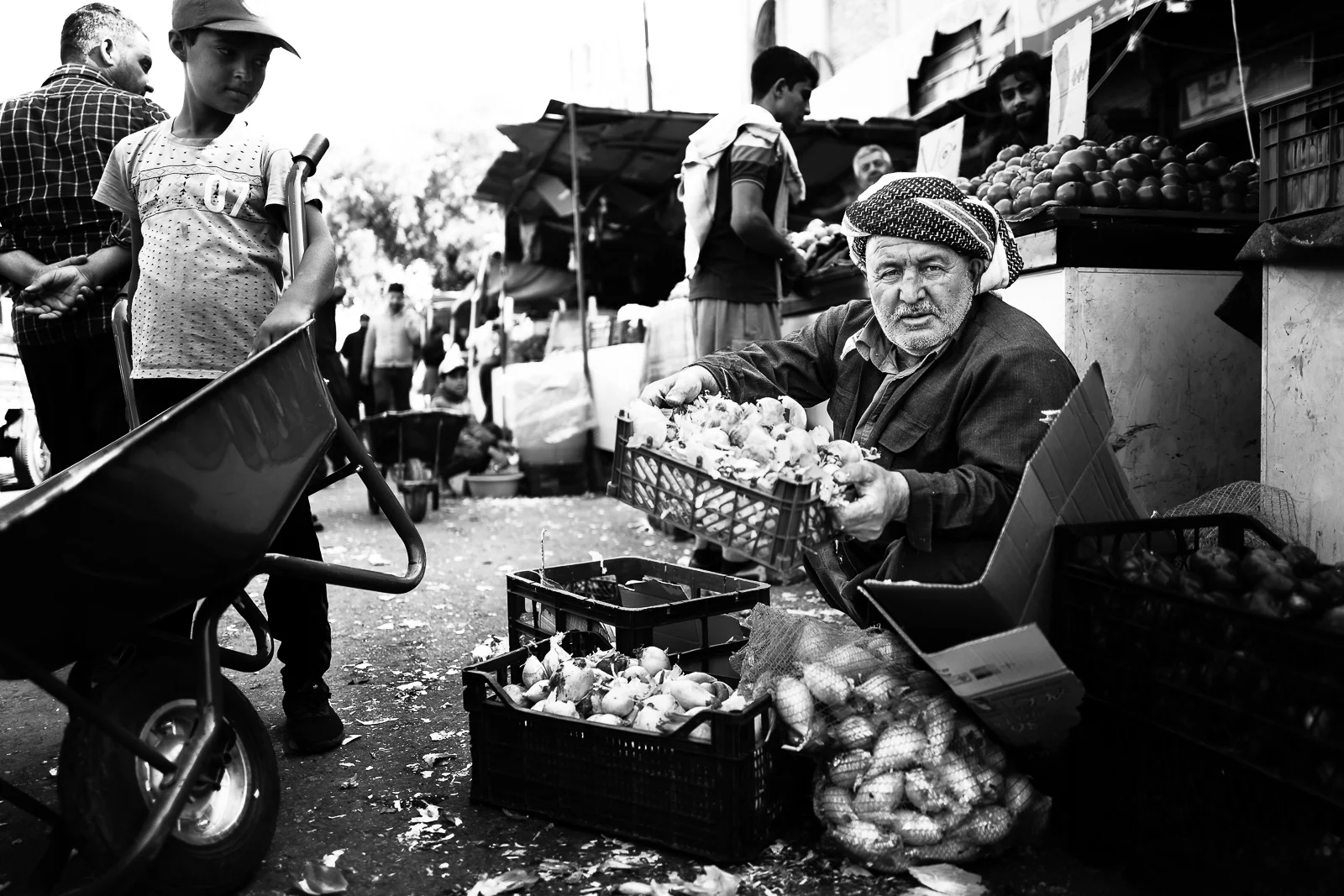 A seller of onions and potatoes in the Erbil bazaar
