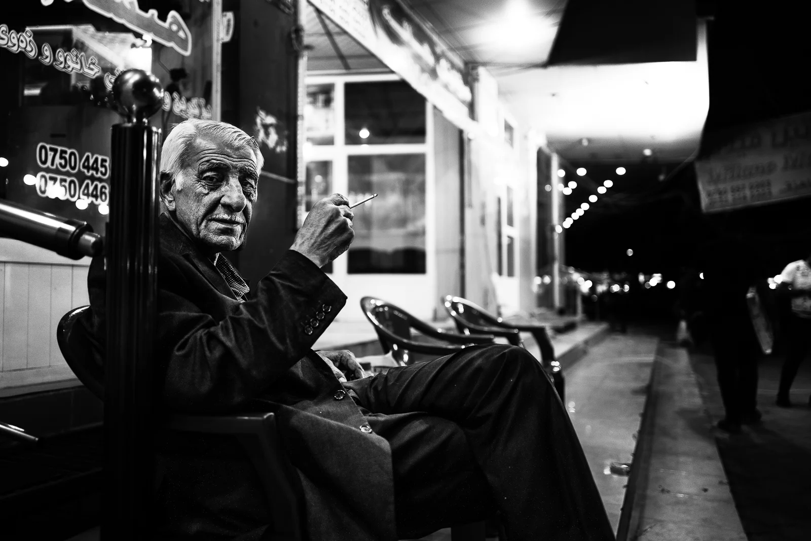 Man is smokind in the night of Erbil