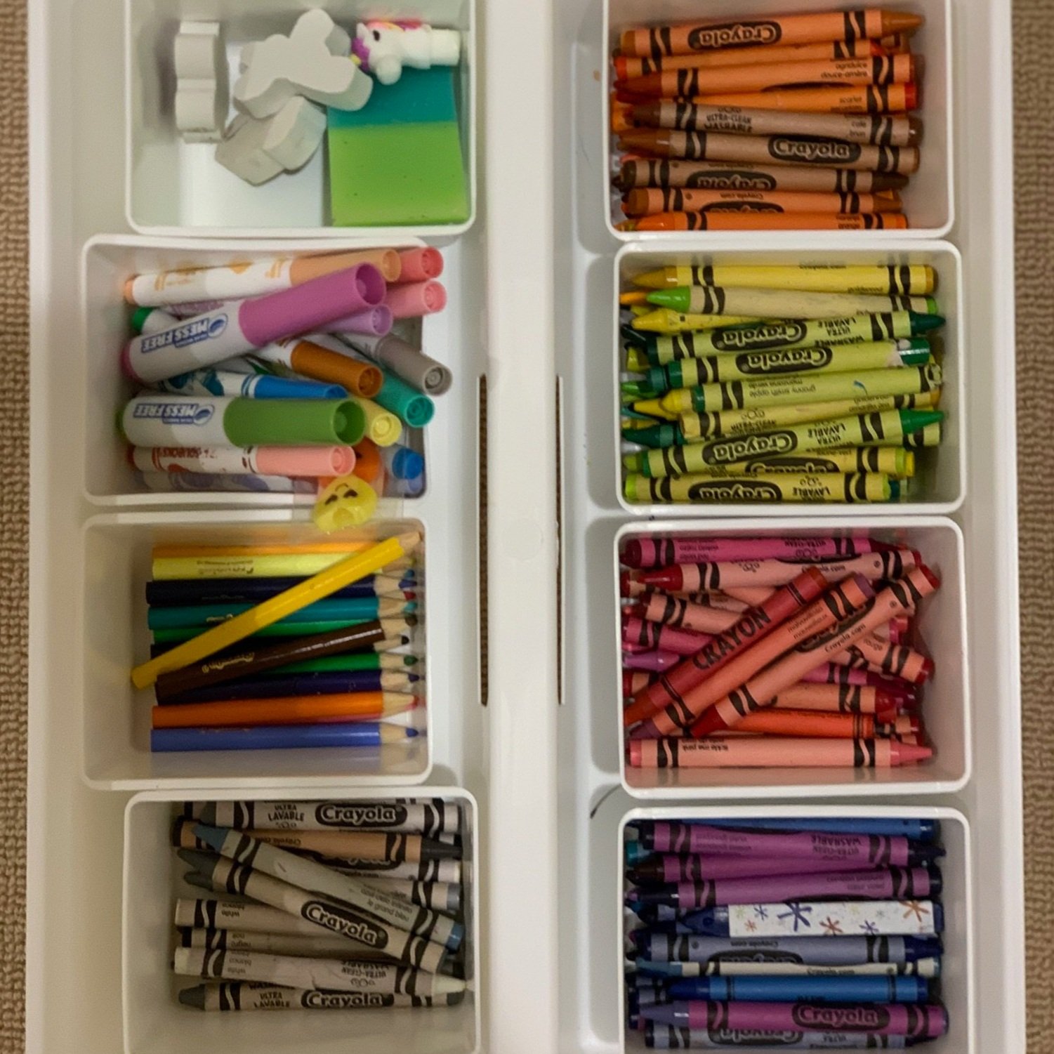 crayons and art supplies organized using white drawer dividers