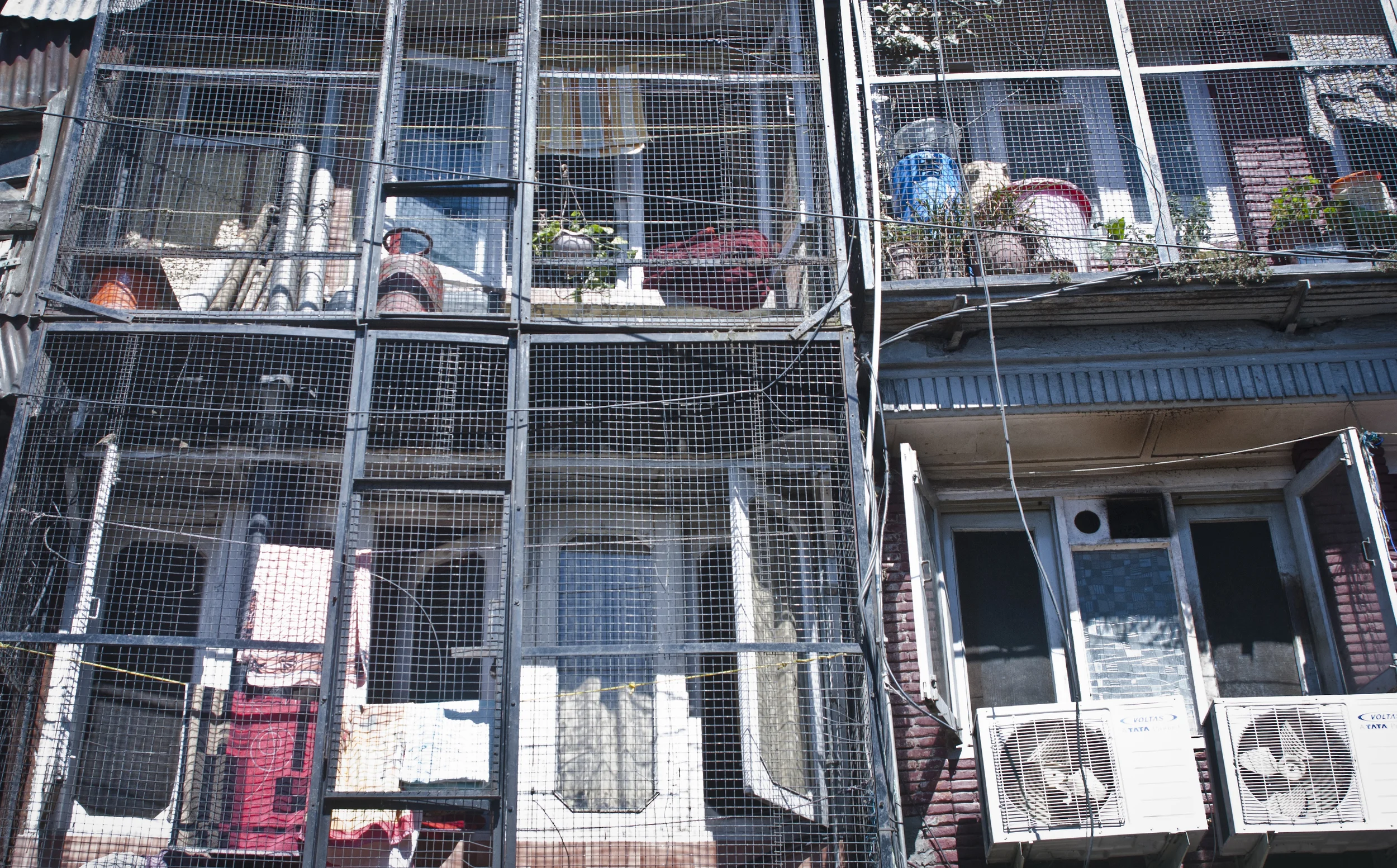 Cages are put around porches to protect homes and belongings from monkey intruders