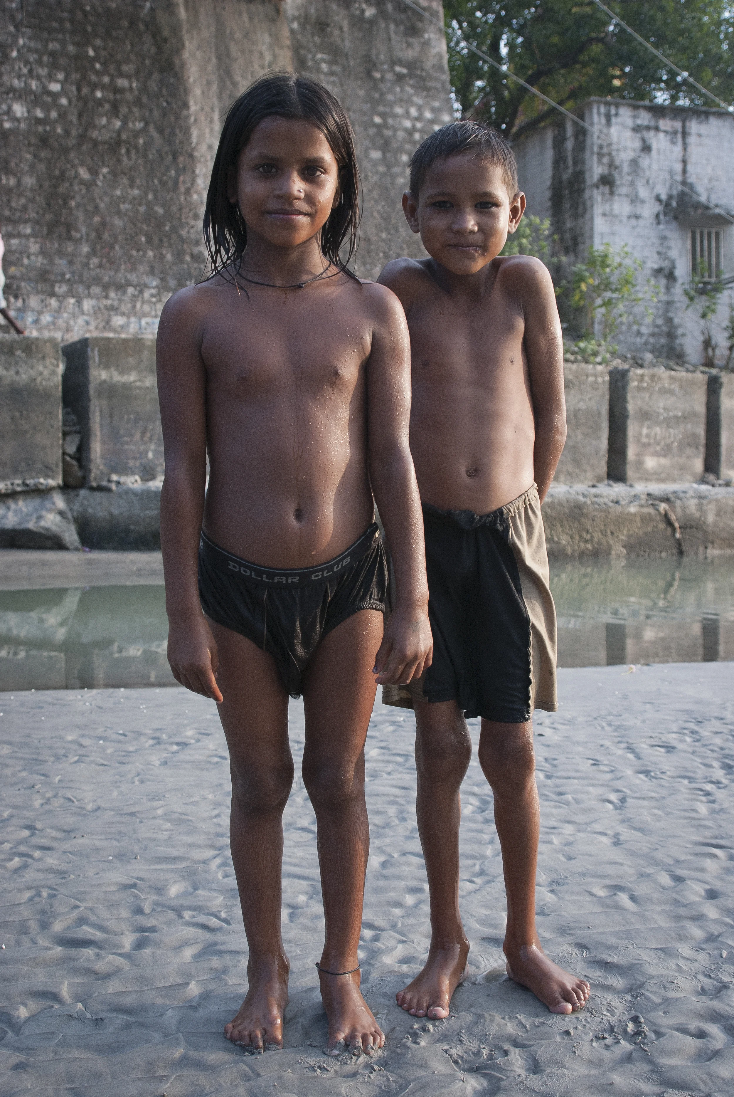 Young boys local to the region play in the waters under the bridge. Passerby on the the bridge often throw them candy. 