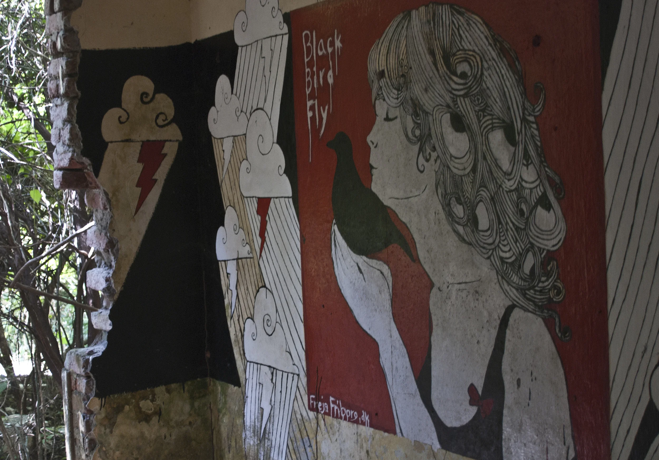Artwork memorializing The Beatles' time at the Ashram decorates the remnants of the buildings. 
