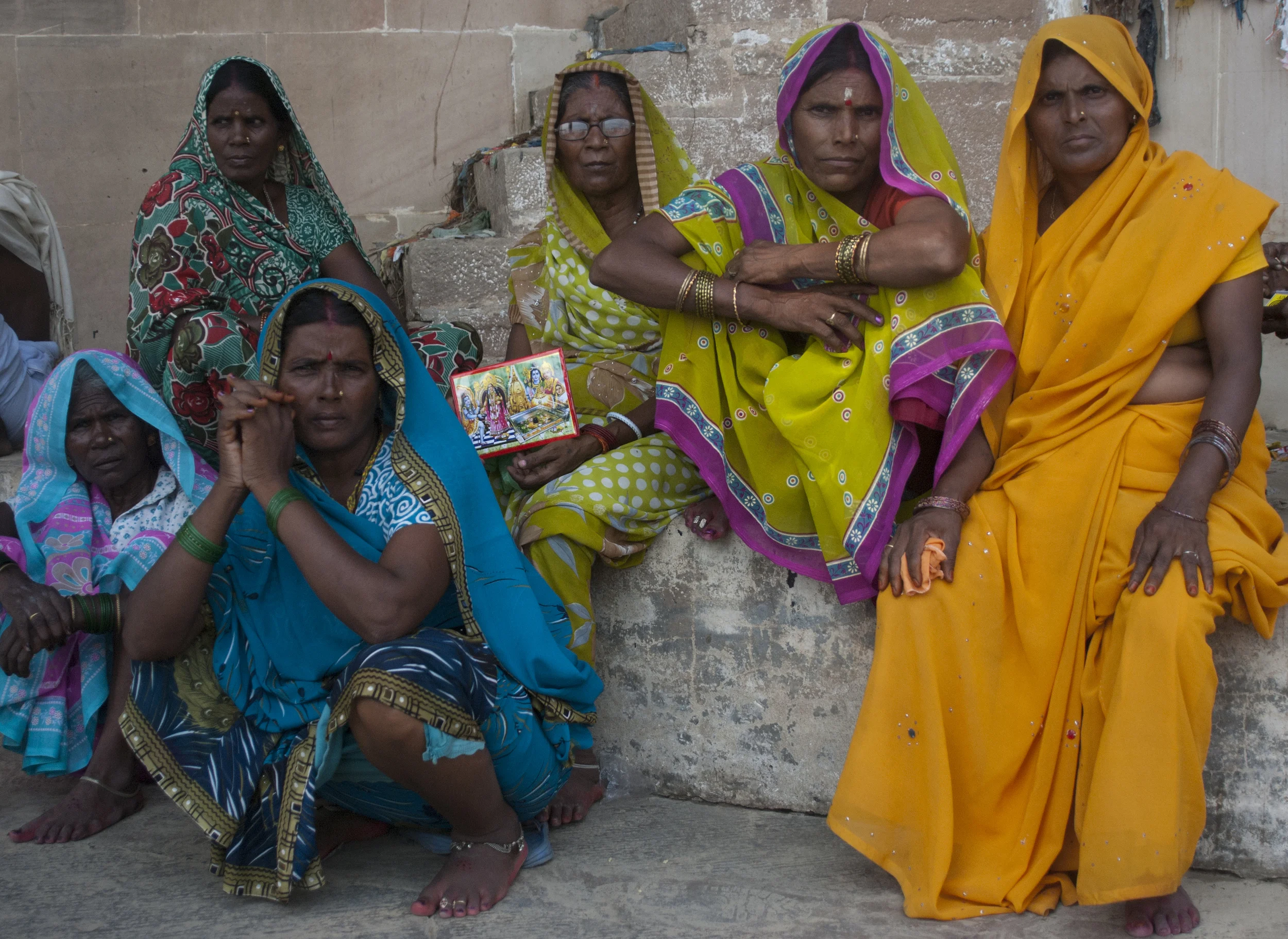 Varanasi women perch on a staircase outside of the burning ghats in Varanasi. 