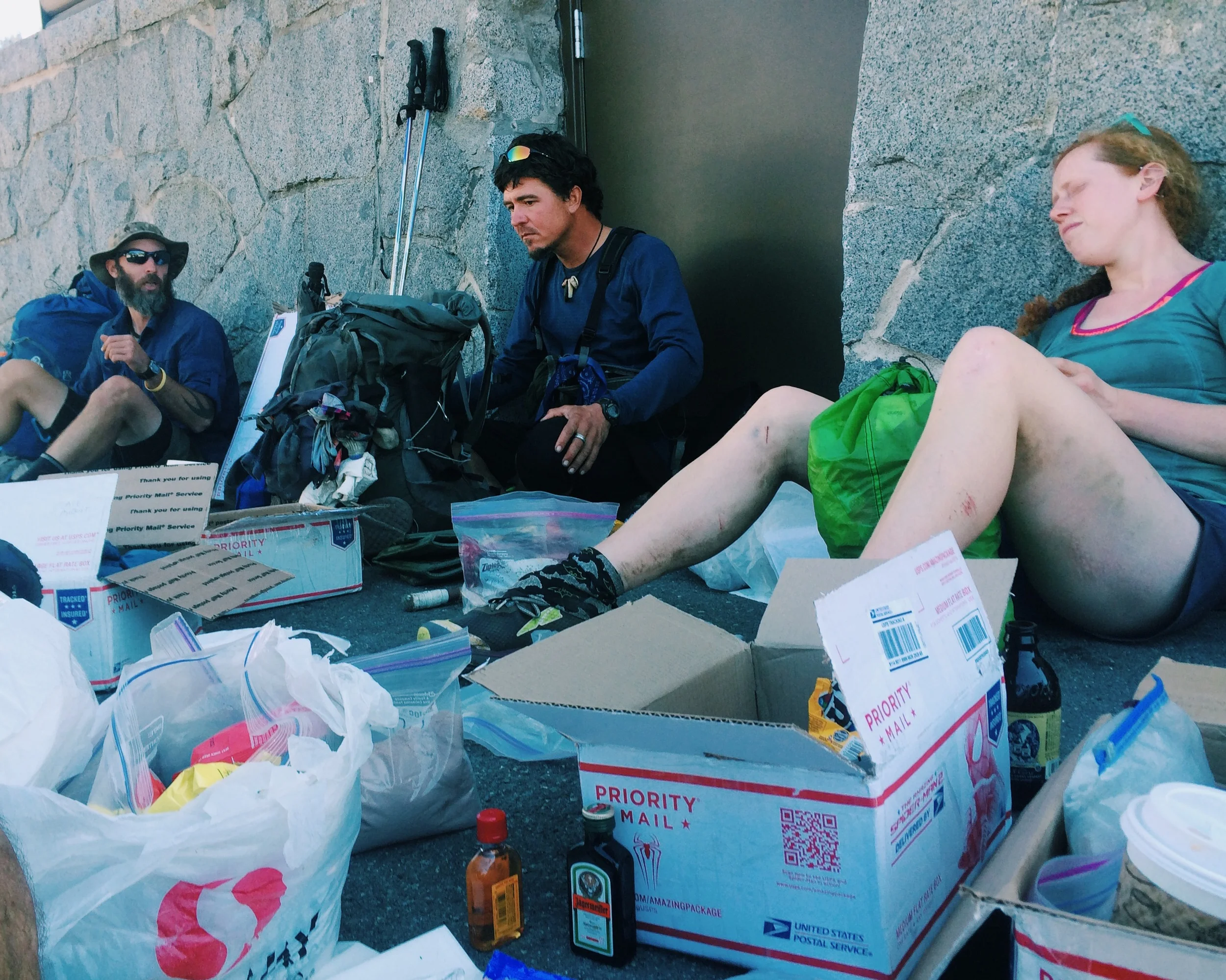 Hiker trash hanging out, going through resupply boxes in Snoqualmie Pass. (Smokes, Trail Dancer and Frizzle)