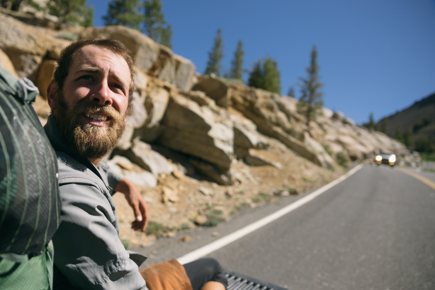 Dan hitching in the back of a pickup to Kennedy Meadows Resort in central California. We had to ride with the gate down because the bed was so full.