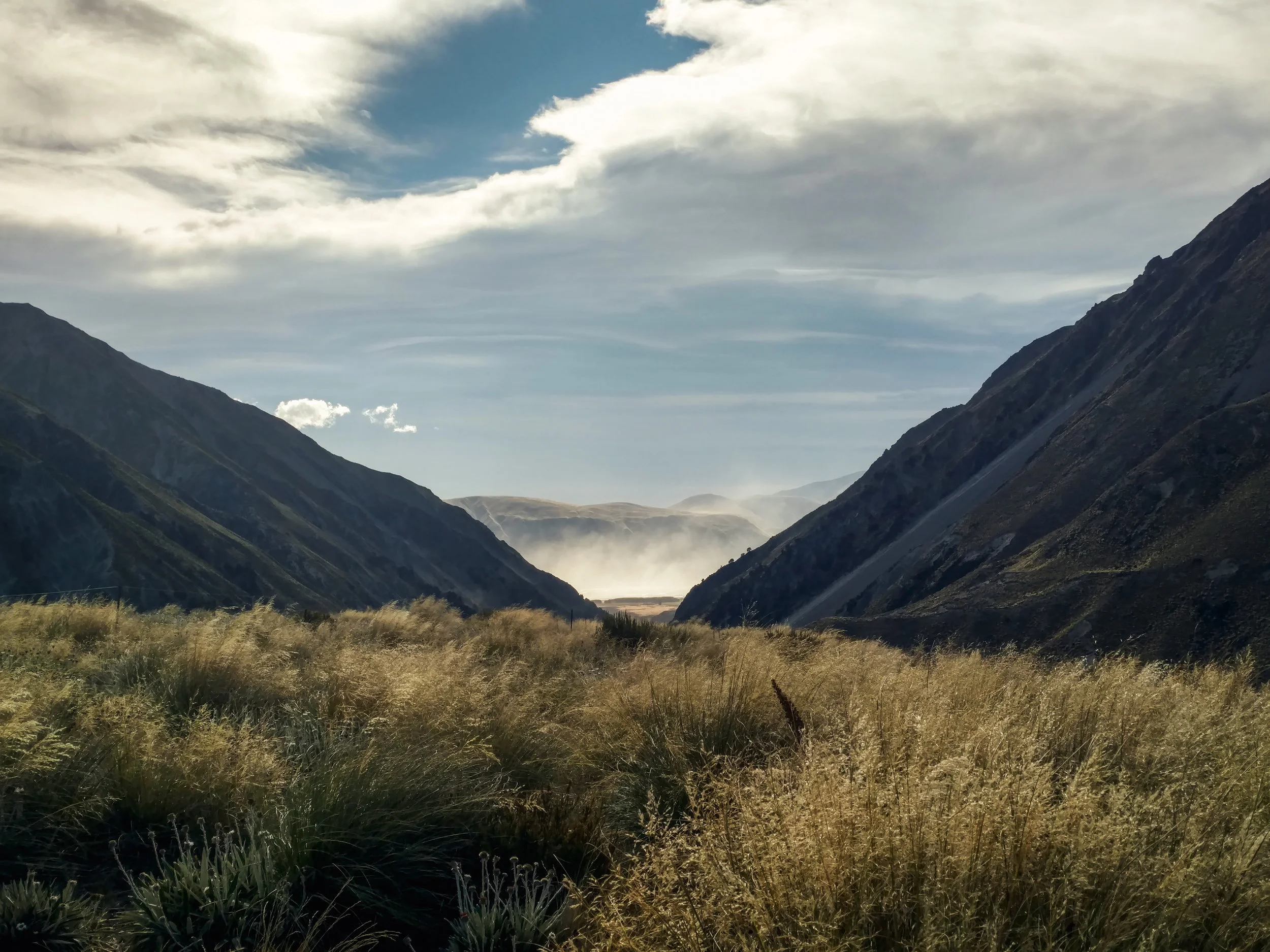Looking back down at the dust storm still raging in the valley below made us glad to be past the Rangitata. photo/ Molly